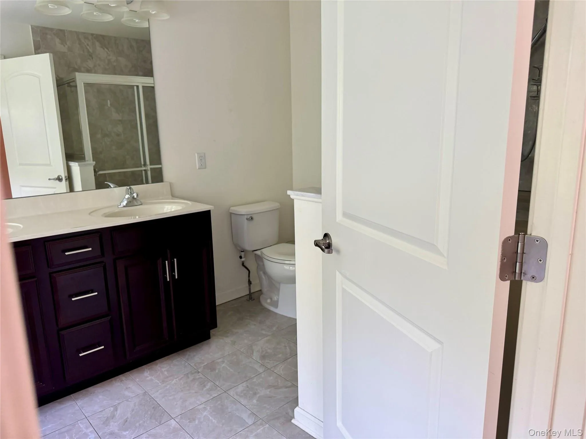 Bathroom with vanity and a shower stall Bathroom with vanity and a shower stall