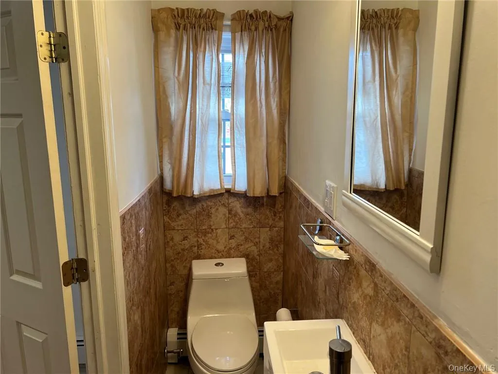 Bathroom with tile walls and toilet Bathroom with tile walls and toilet