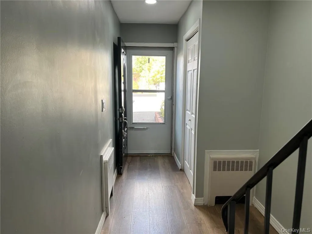 Entryway featuring radiator and light hardwood / wood-style flooring Entryway featuring radiator and light hardwood / wood-style flooring