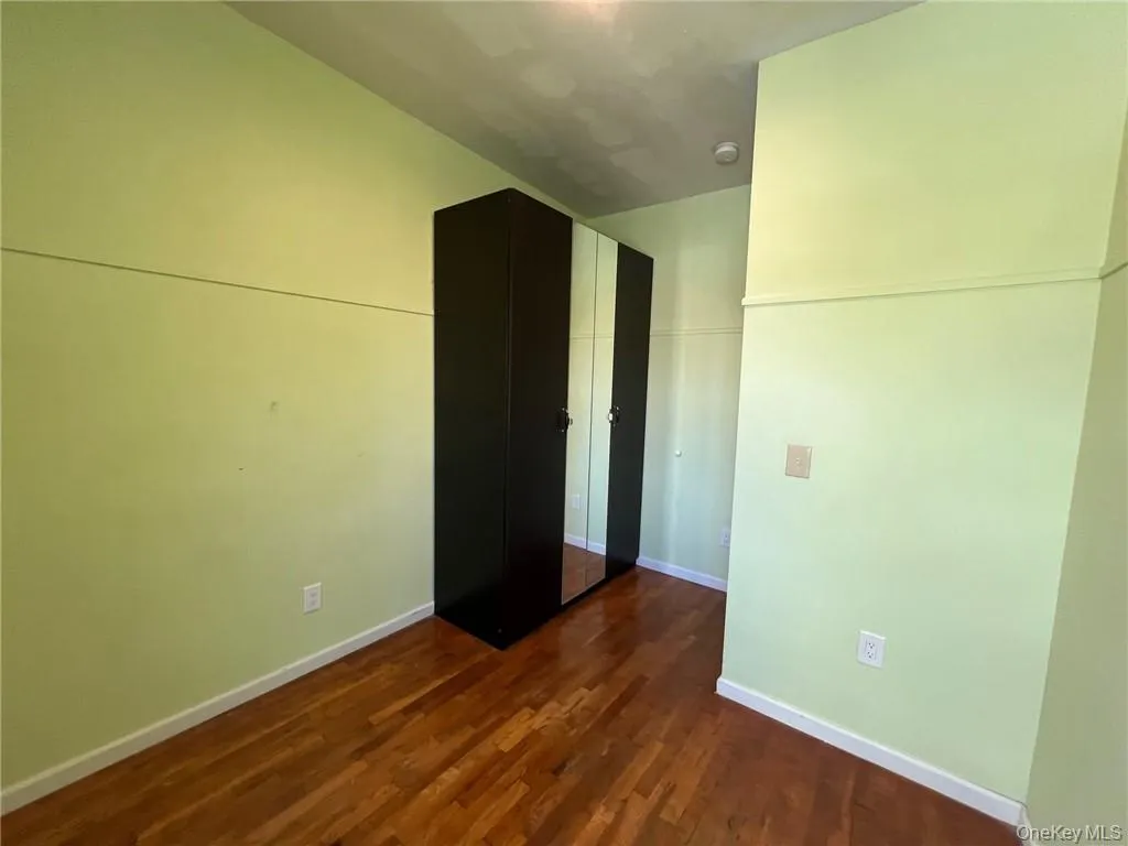 Spare room featuring dark hardwood / wood-style flooring Spare room featuring dark hardwood / wood-style flooring