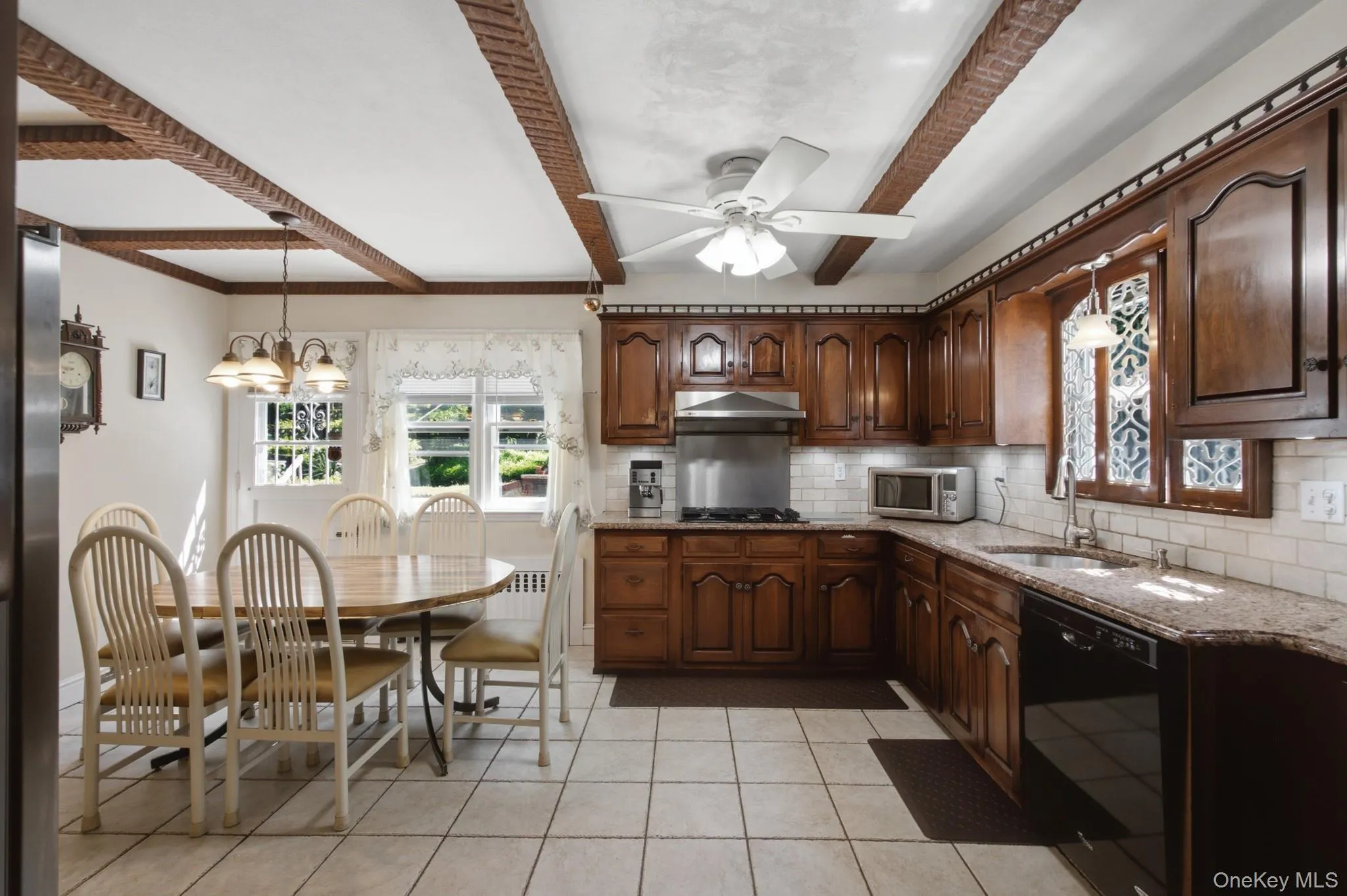 Large eat-in kitchen with rustic wood beams, granite counter-tops, and a charming pass-through to the dining room. Large eat-in kitchen with rustic wood beams, granite counter-tops, and a charming pass-through to the dining room.