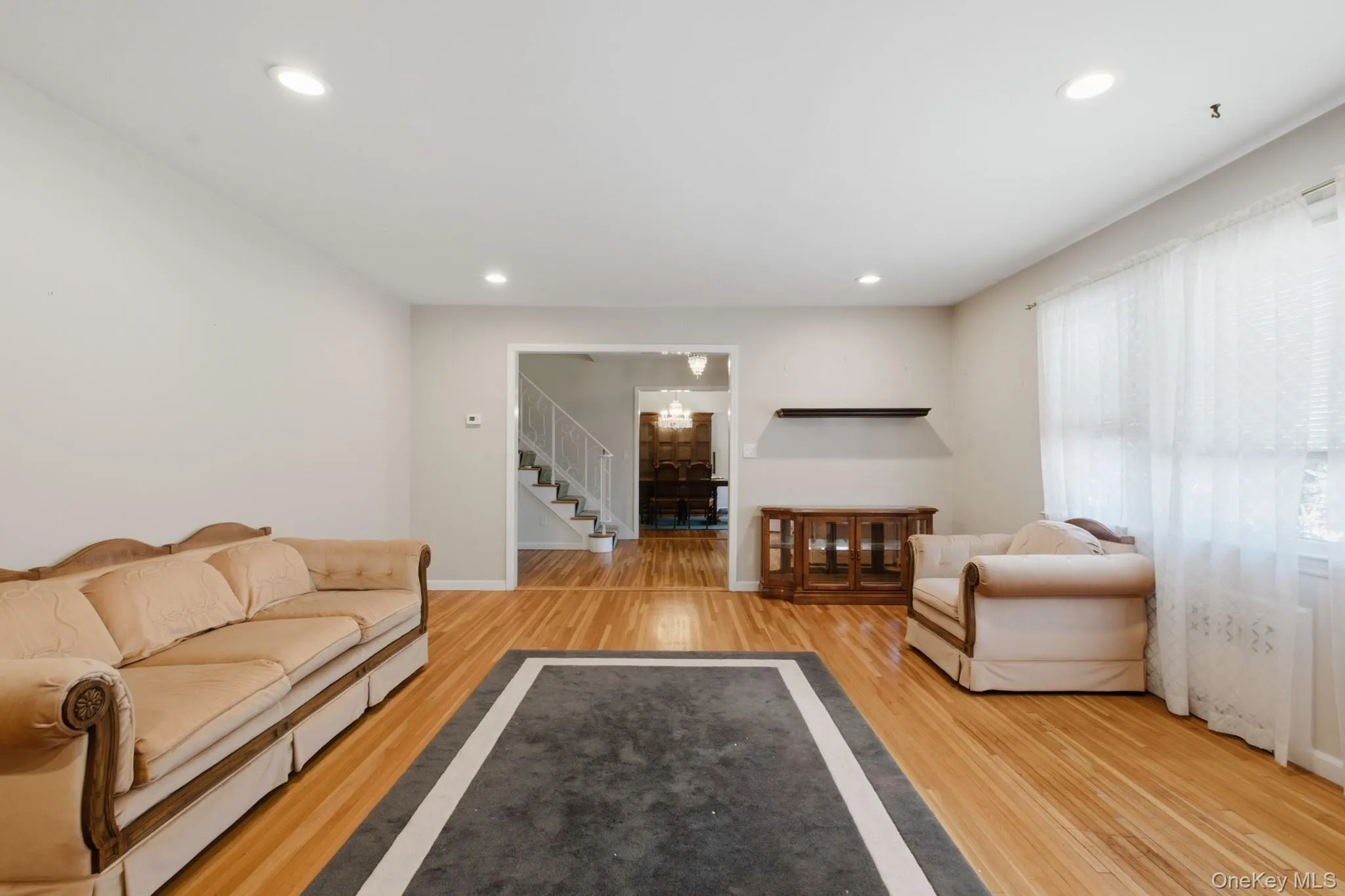 Alternate view of the living room flowing seamlessly into the foyer and formal dining room. Alternate view of the living room flowing seamlessly into the foyer and formal dining room.