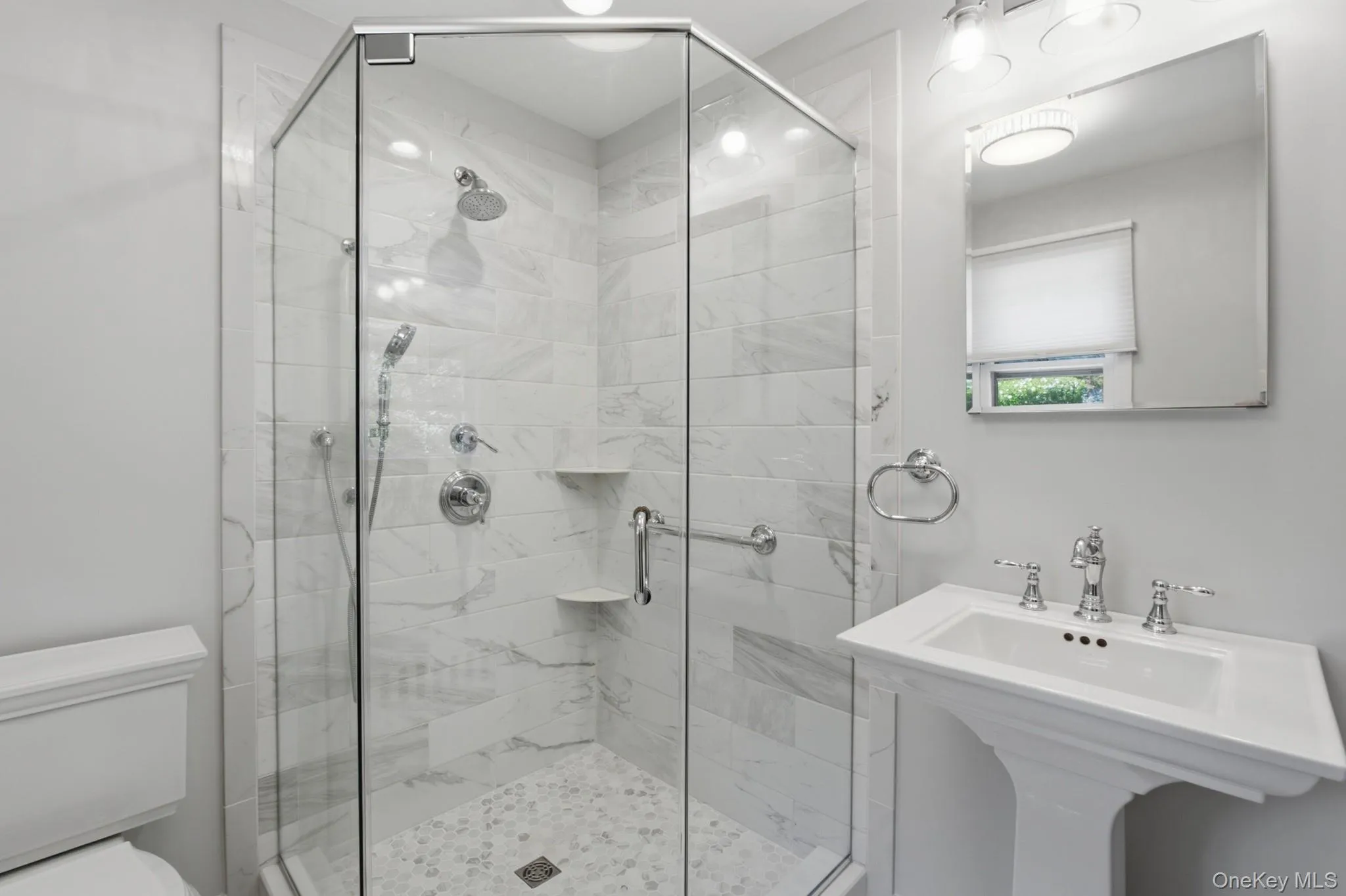 Renovated en-suite bath featuring a spacious walk-in shower and modern finishes. Renovated en-suite bath featuring a spacious walk-in shower and modern finishes.