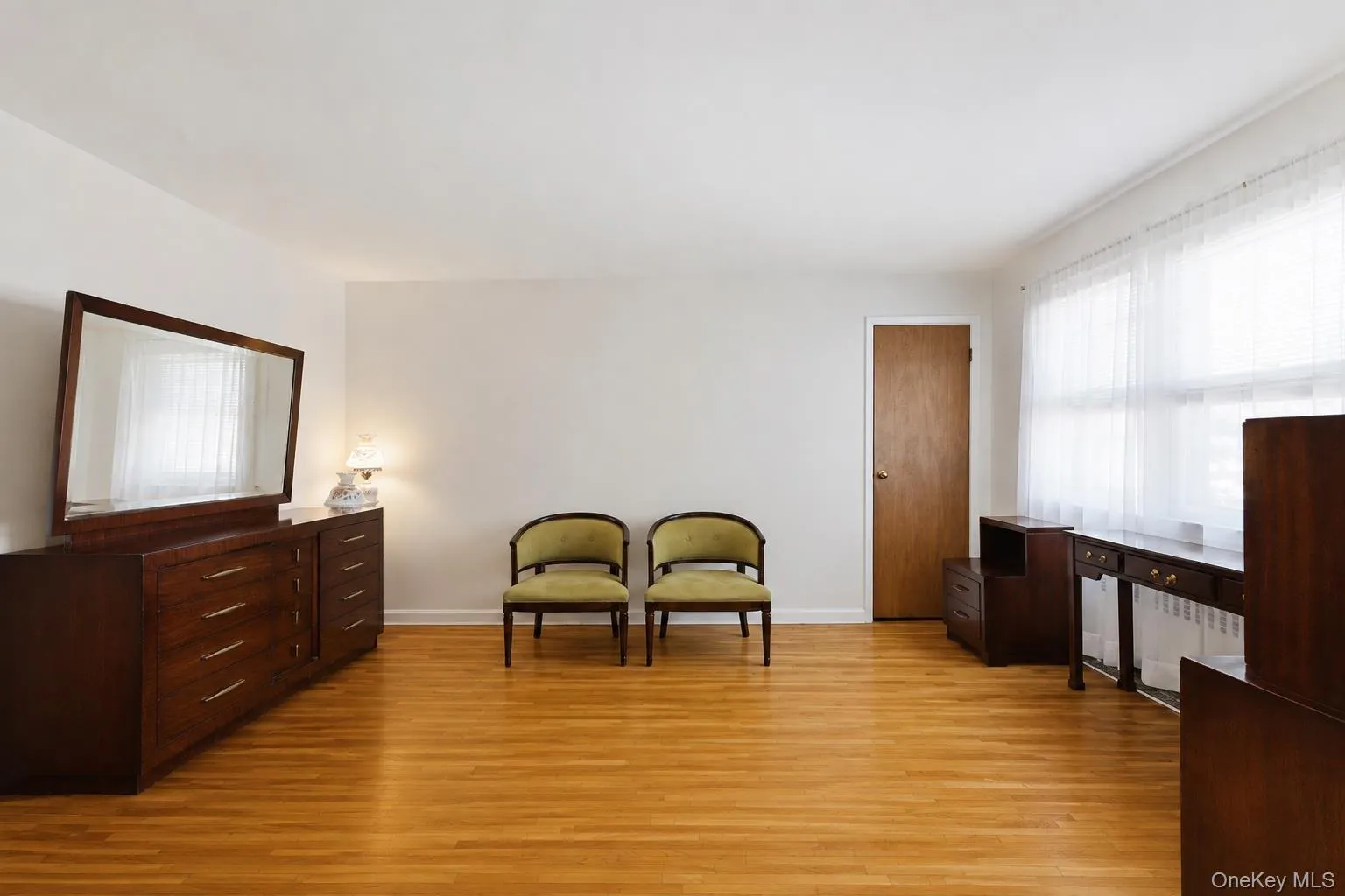 Alternate view of the primary bedroom highlighting abundant natural light and additional closet space. Alternate view of the primary bedroom highlighting abundant natural light and additional closet space.