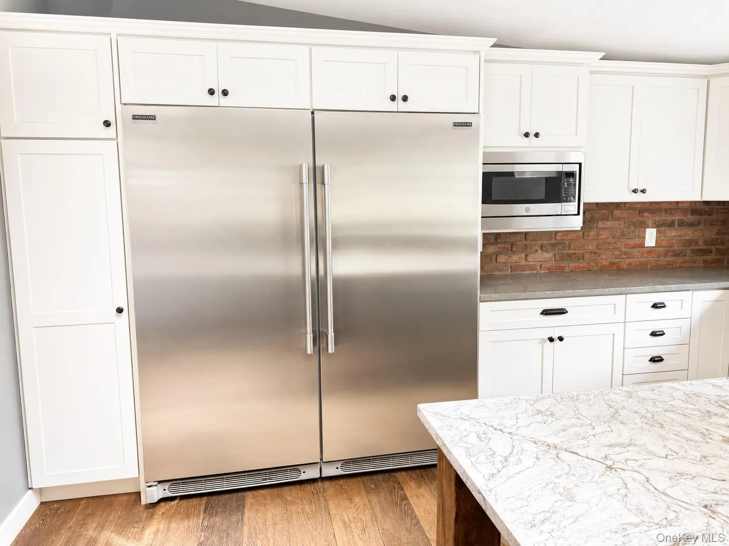 Expansive kitchen featuring dual stainless steel refrigerator Expansive kitchen featuring dual stainless steel refrigerator