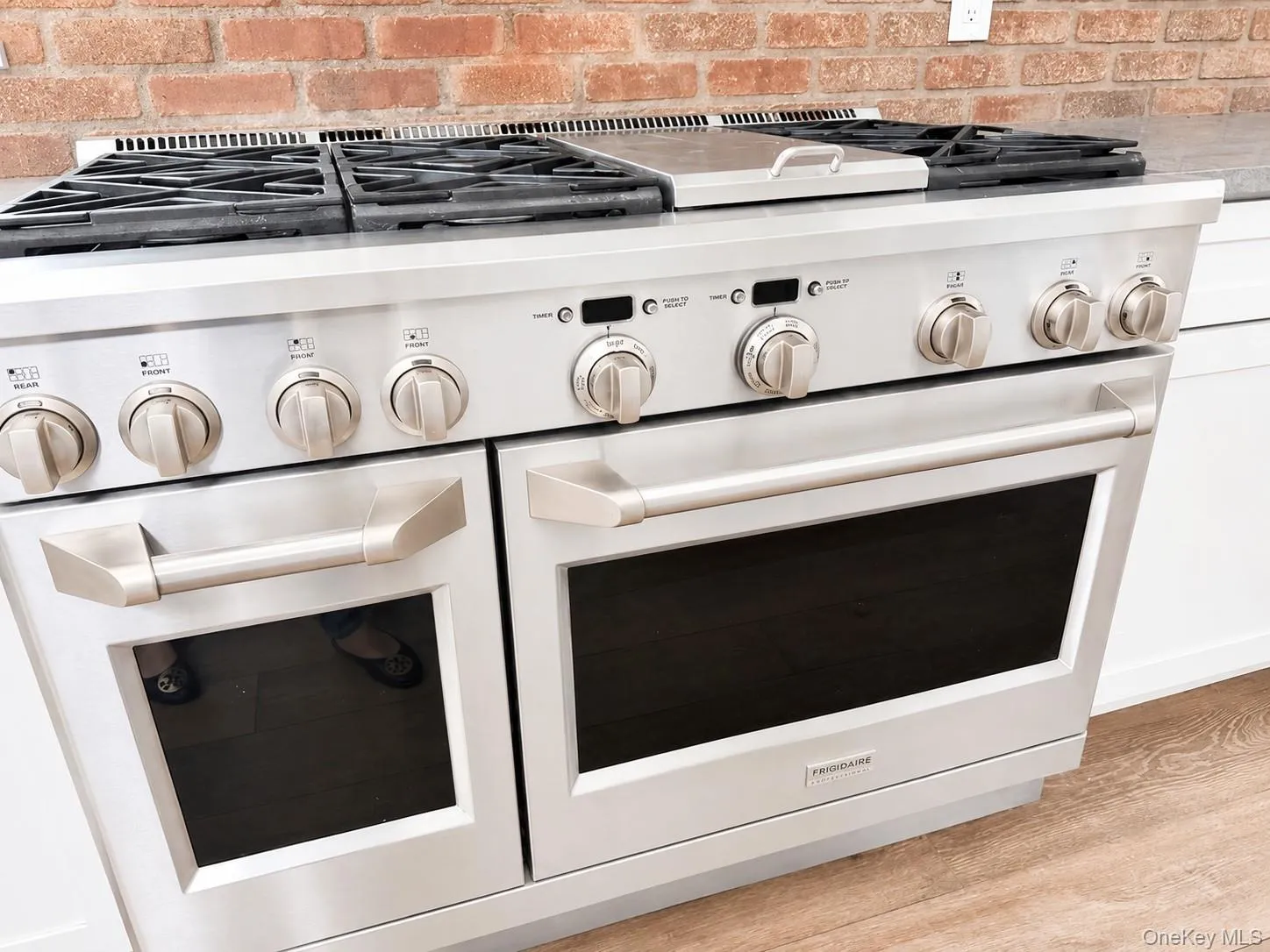 Professional-grade stainless steel range with gas cooktop, dual ovens, and integrated griddle feature. Professional-grade stainless steel range with gas cooktop, dual ovens, and integrated griddle feature.