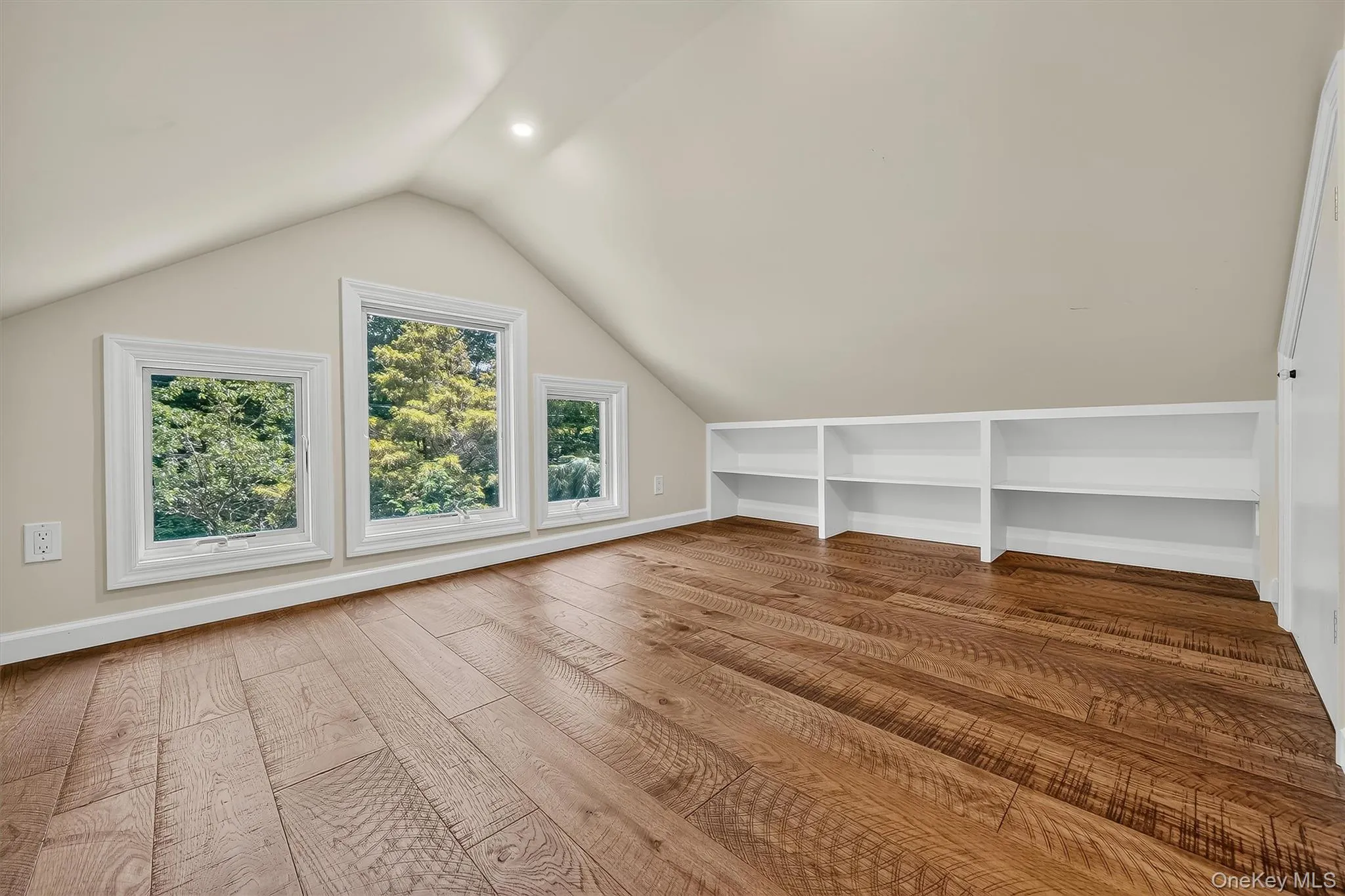 Hardwood-finish flooring, built-in shelving, white trim windows, sloped ceiling, recessed lighting Hardwood-finish flooring, built-in shelving, white trim windows, sloped ceiling, recessed lighting
