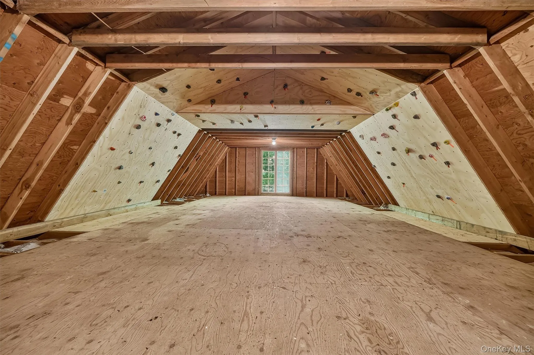 Exposed wood beam ceiling with wood framing, window with exterior landscape, and built-in climbing wall and ceiling. Core training at it's best! Exposed wood beam ceiling with wood framing, window with exterior landscape, and built-in climbing wall and ceiling. Core training at it's best!