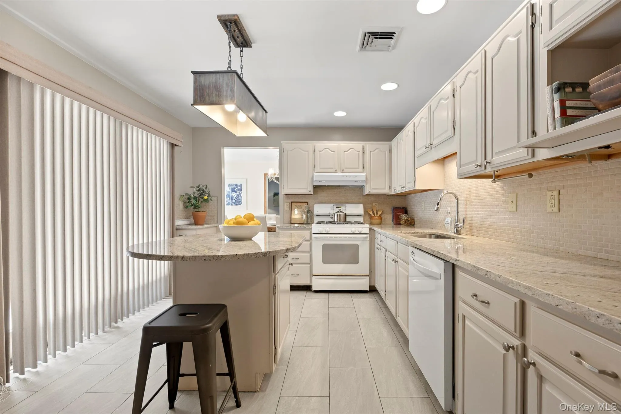 Spacious kitchen with access to the large deck makes outside entertaining easy Spacious kitchen with access to the large deck makes outside entertaining easy