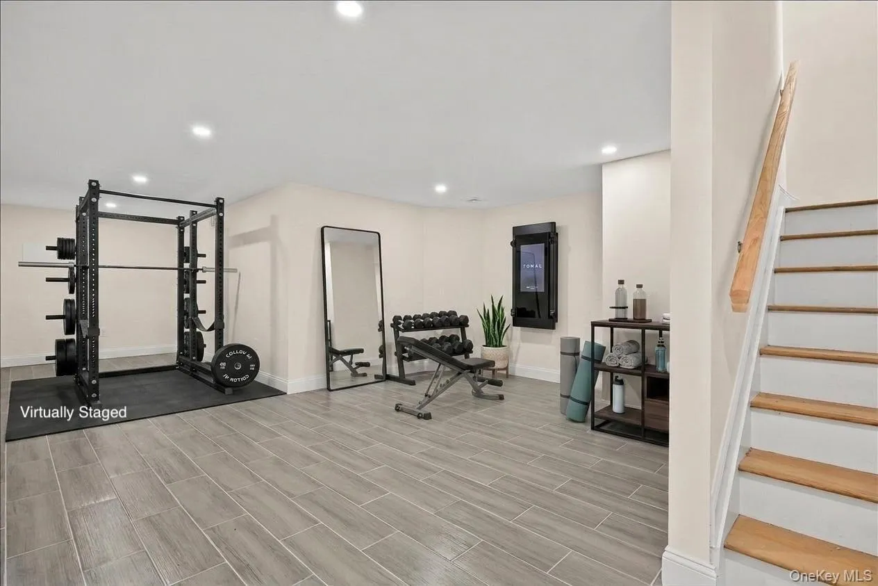 virtually staged gym set up/area as you step into the basement virtually staged gym set up/area as you step into the basement