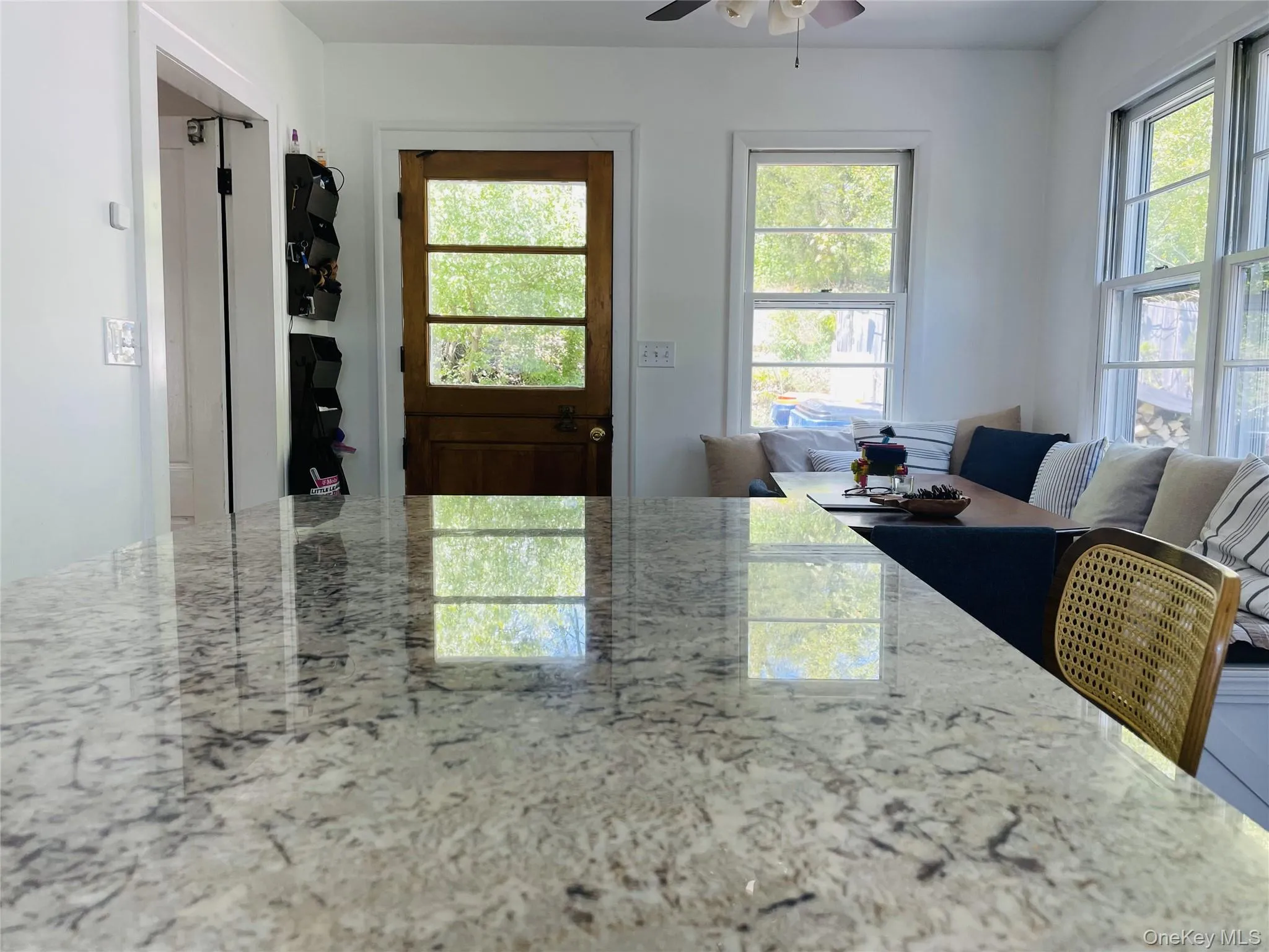 Kitchen with a ceiling fan, open floor plan, and plenty of natural light Kitchen with a ceiling fan, open floor plan, and plenty of natural light