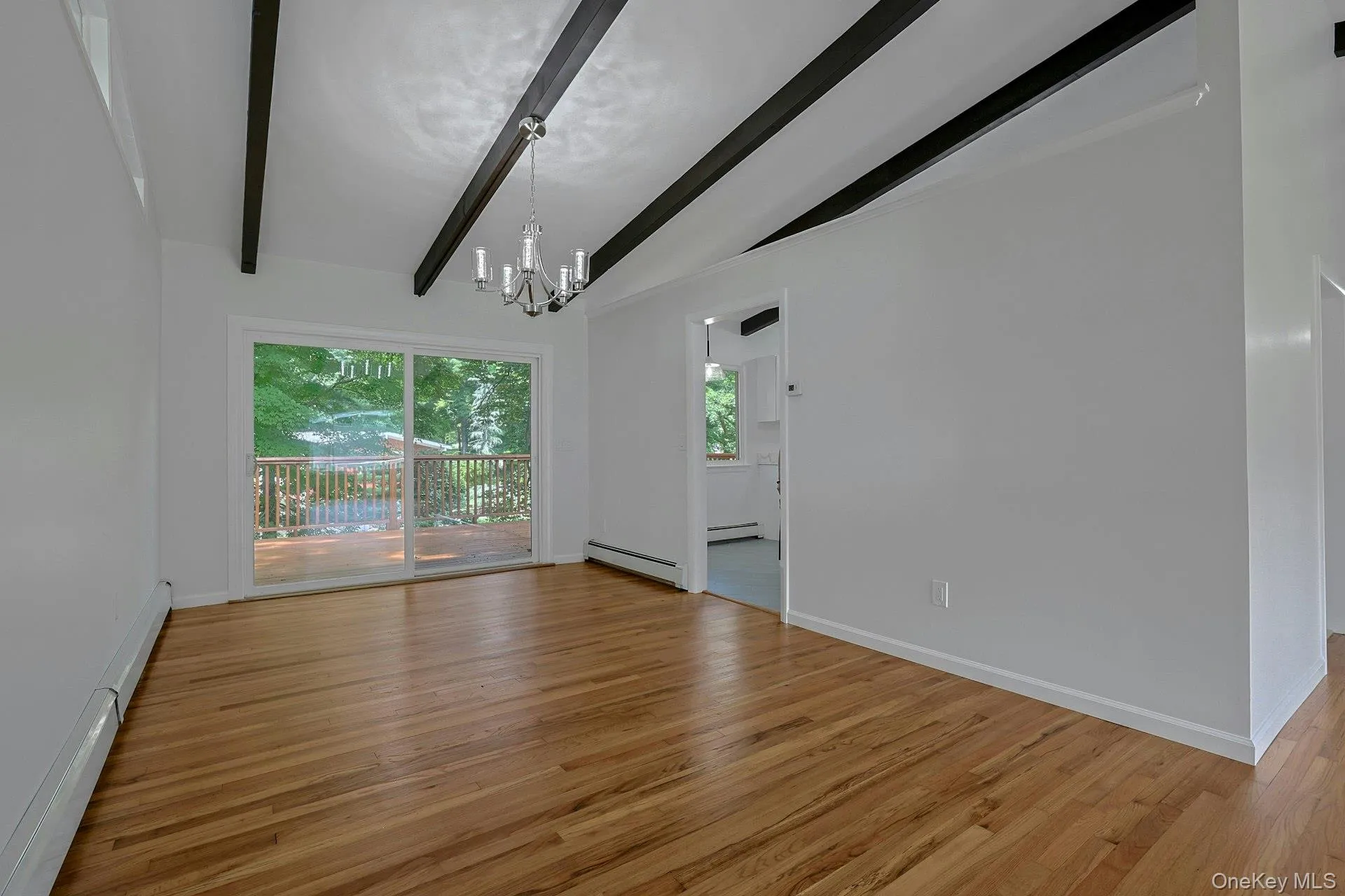 Spacious dining room with sliders to the oversized deck Spacious dining room with sliders to the oversized deck