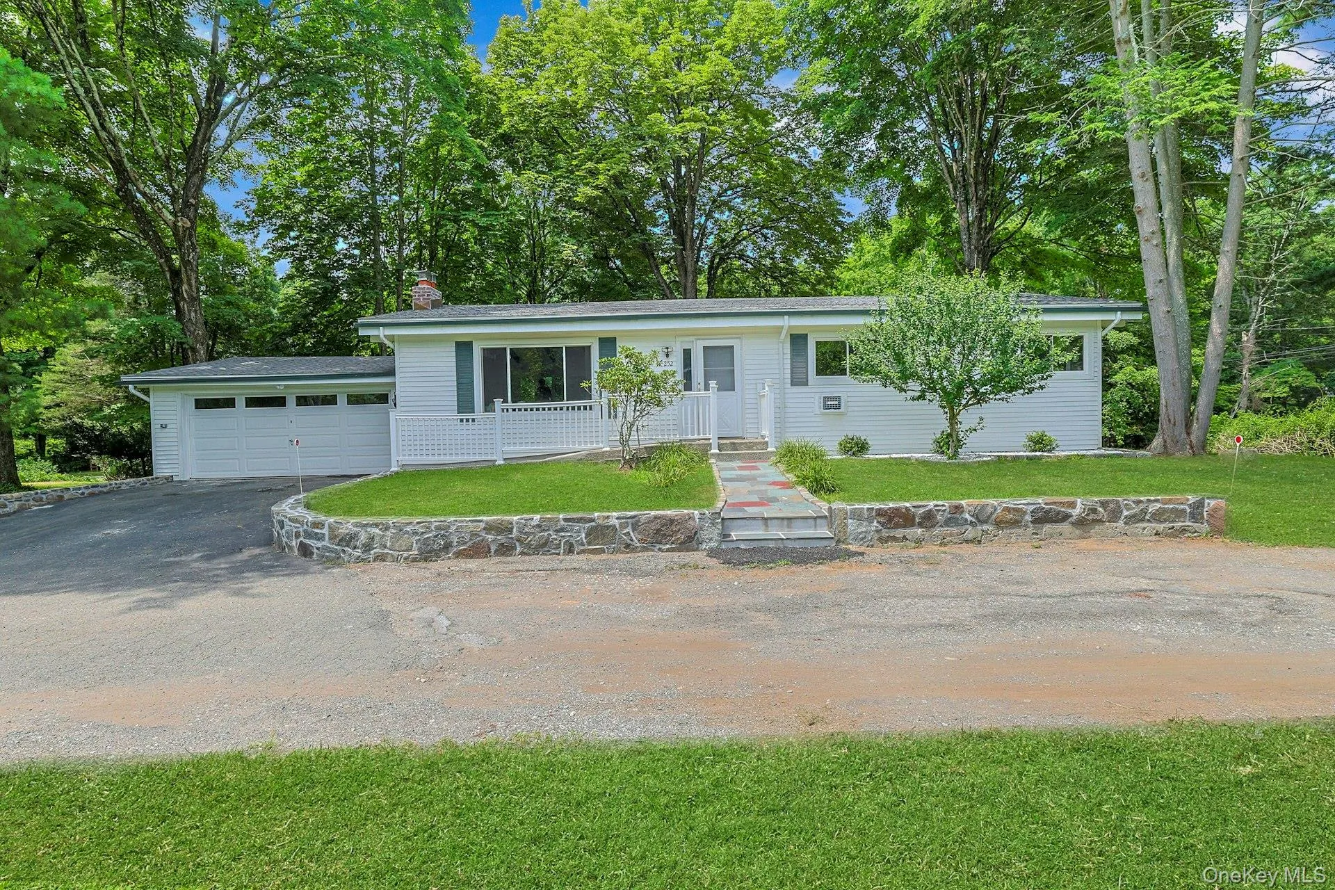 Front of home featuring front lawn and stonework Front of home featuring front lawn and stonework