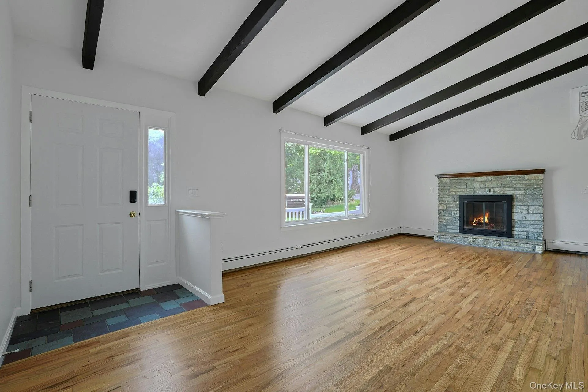 Living room with stunning hardwood floors, fireplace and beamed cathedral ceiling Living room with stunning hardwood floors, fireplace and beamed cathedral ceiling