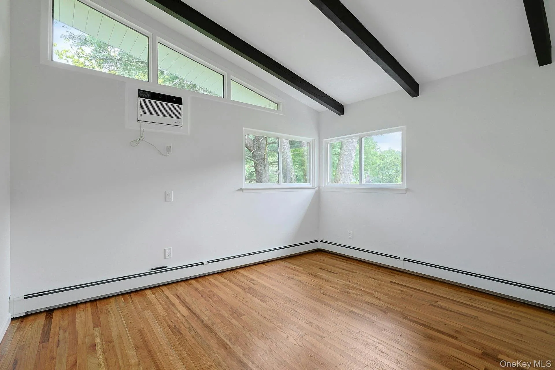 Bedroom # 2 with hardwood floor and beamed ceiling Bedroom # 2 with hardwood floor and beamed ceiling