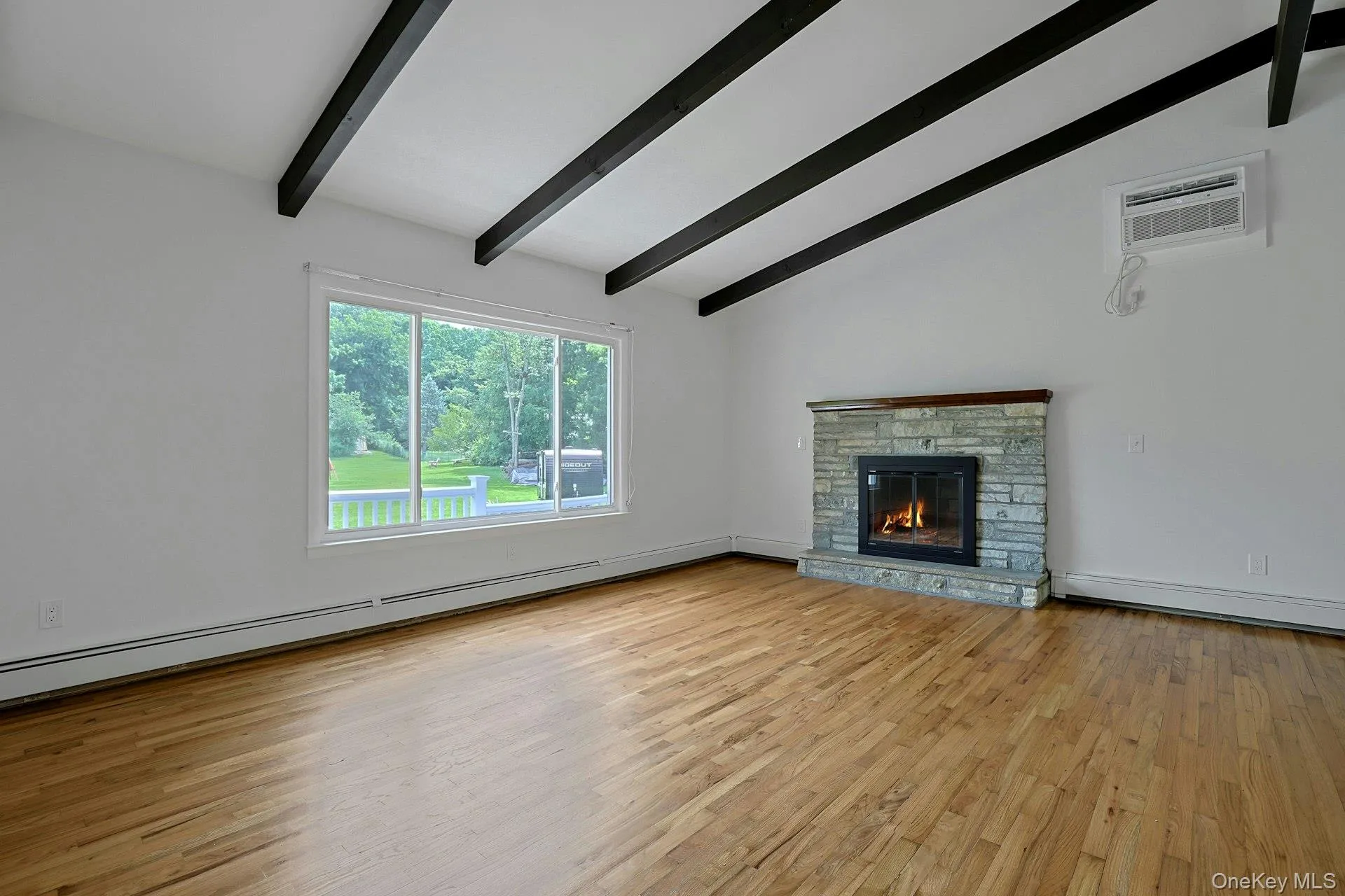 Another view of the living room featuring the large window for lots of natural light Another view of the living room featuring the large window for lots of natural light