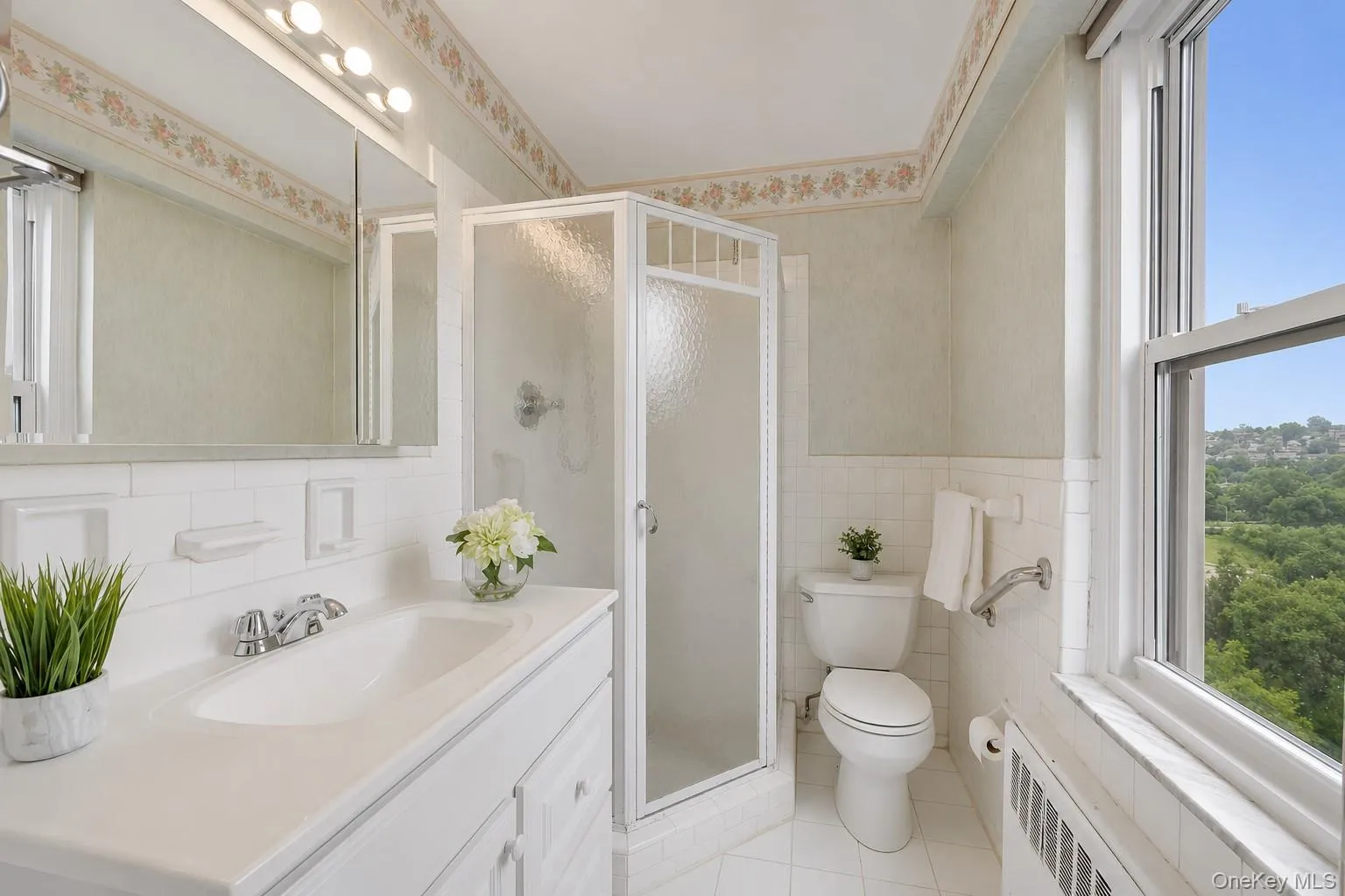 Bright en-suite bath with a walk-in shower and large window that fills the space with natural light. Bright en-suite bath with a walk-in shower and large window that fills the space with natural light.