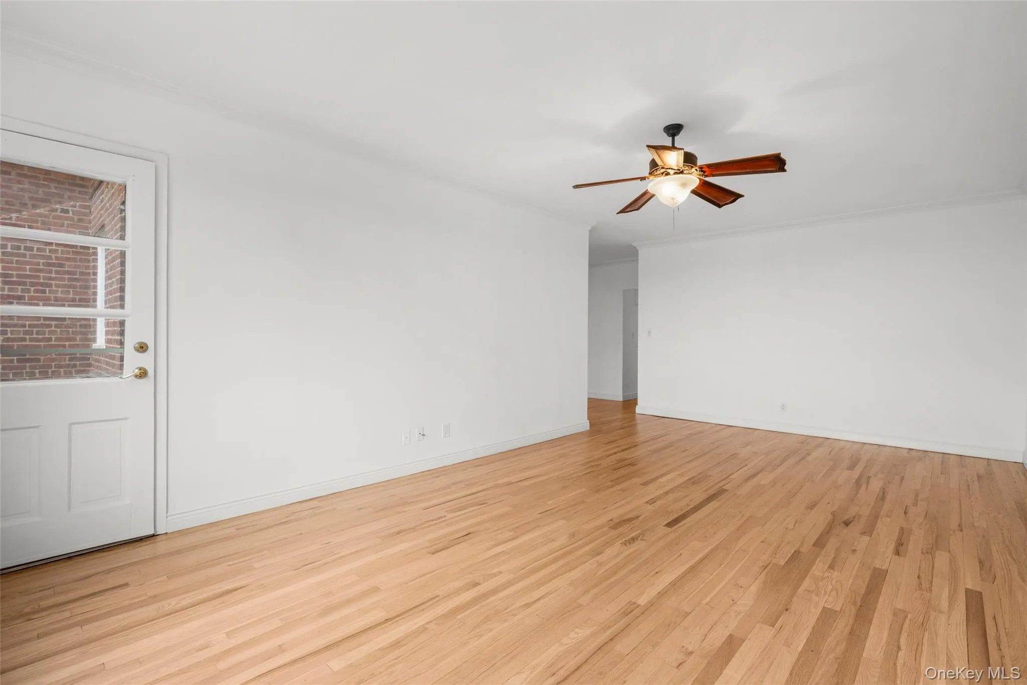 View towards hallway and bedroom wing. Door to balcony. View towards hallway and bedroom wing. Door to balcony.