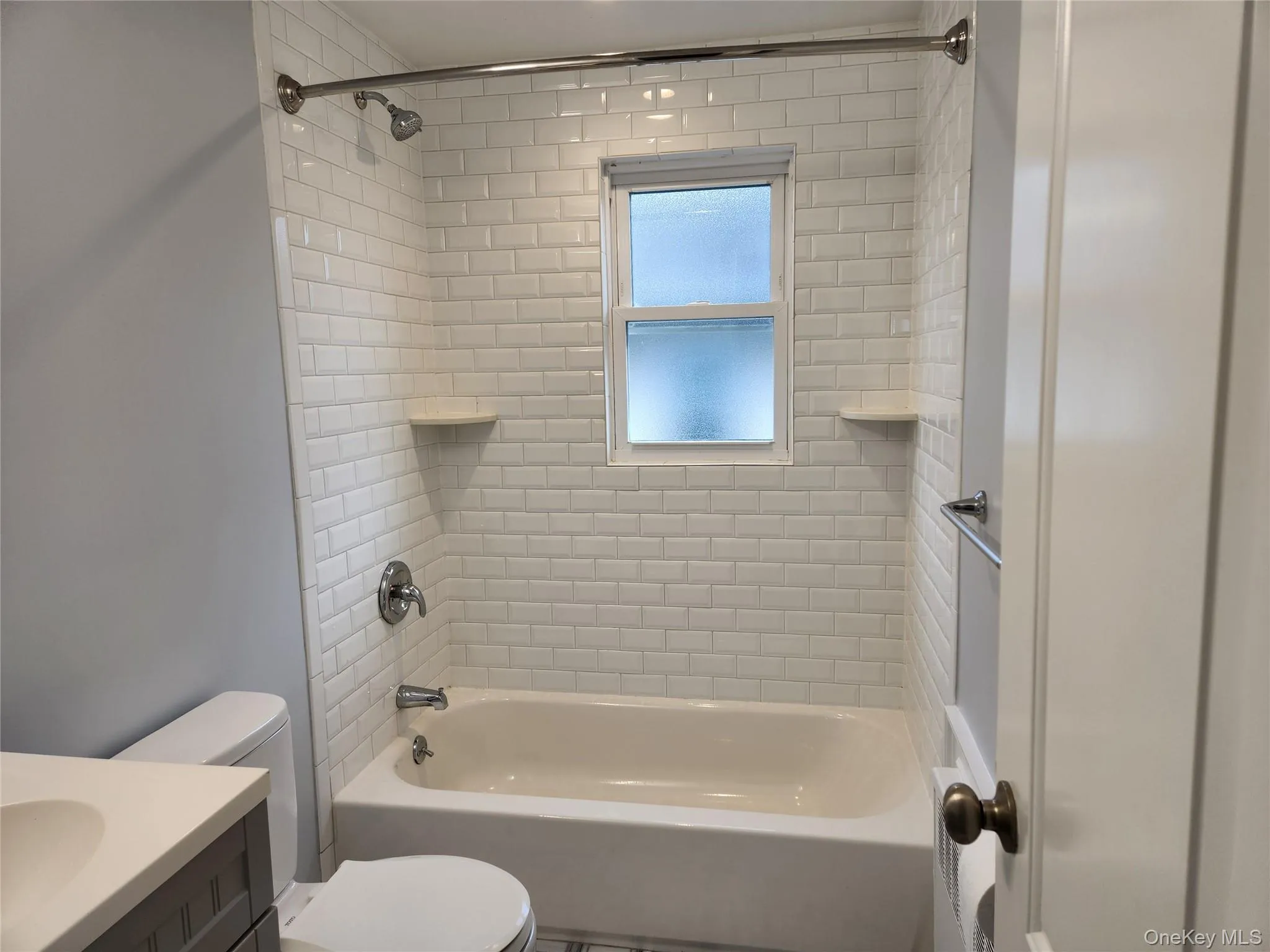 Full bath with shower / bath combination, vanity, and toilet Full bath with shower / bath combination, vanity, and toilet