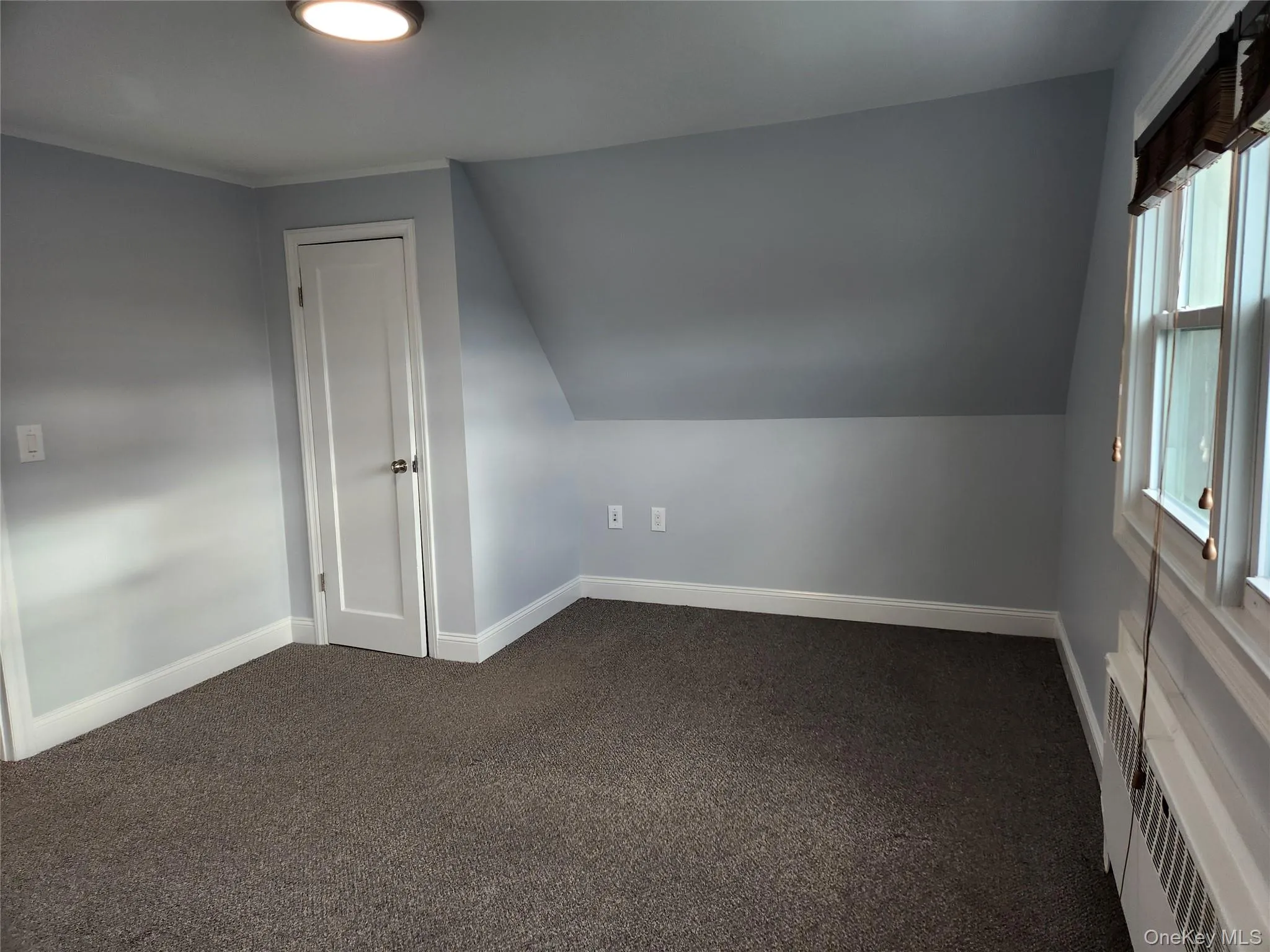 Fully Carpeted, baseboards, radiator, and vaulted ceiling Fully Carpeted, baseboards, radiator, and vaulted ceiling