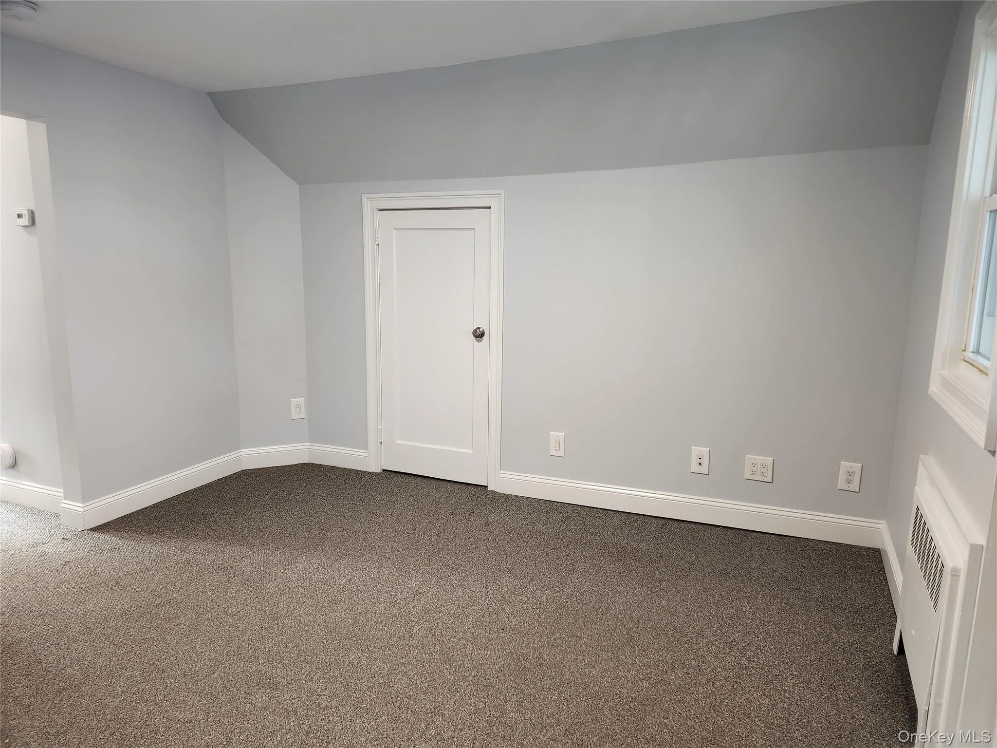 Fully carpeted, baseboards, and lofted ceiling Fully carpeted, baseboards, and lofted ceiling