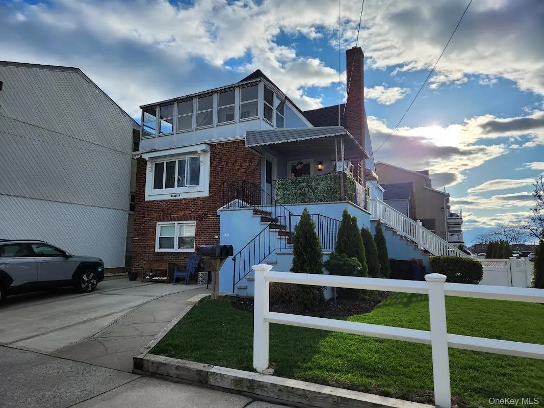 View of front of house featuring brick siding, a front lawn, and a fenced front yard View of front of house featuring brick siding, a front lawn, and a fenced front yard