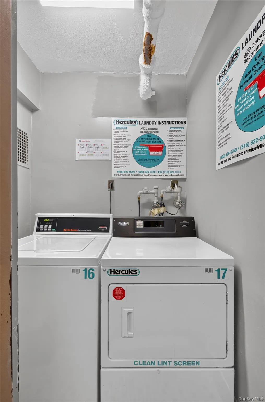 Dedicated laundry room featuring a top-loading washing machine and a front-loading dryer Dedicated laundry room featuring a top-loading washing machine and a front-loading dryer