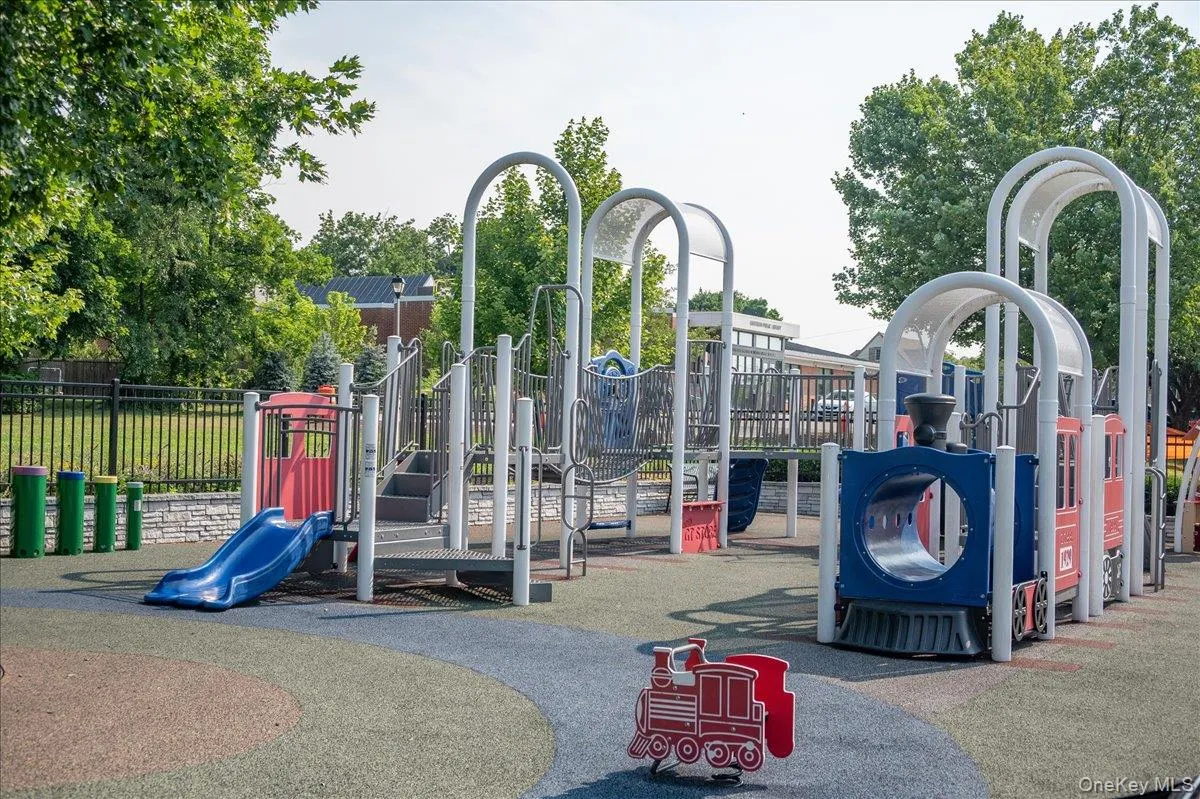 Community playground featuring a multi-level structure with slides and climbing elements Community playground featuring a multi-level structure with slides and climbing elements