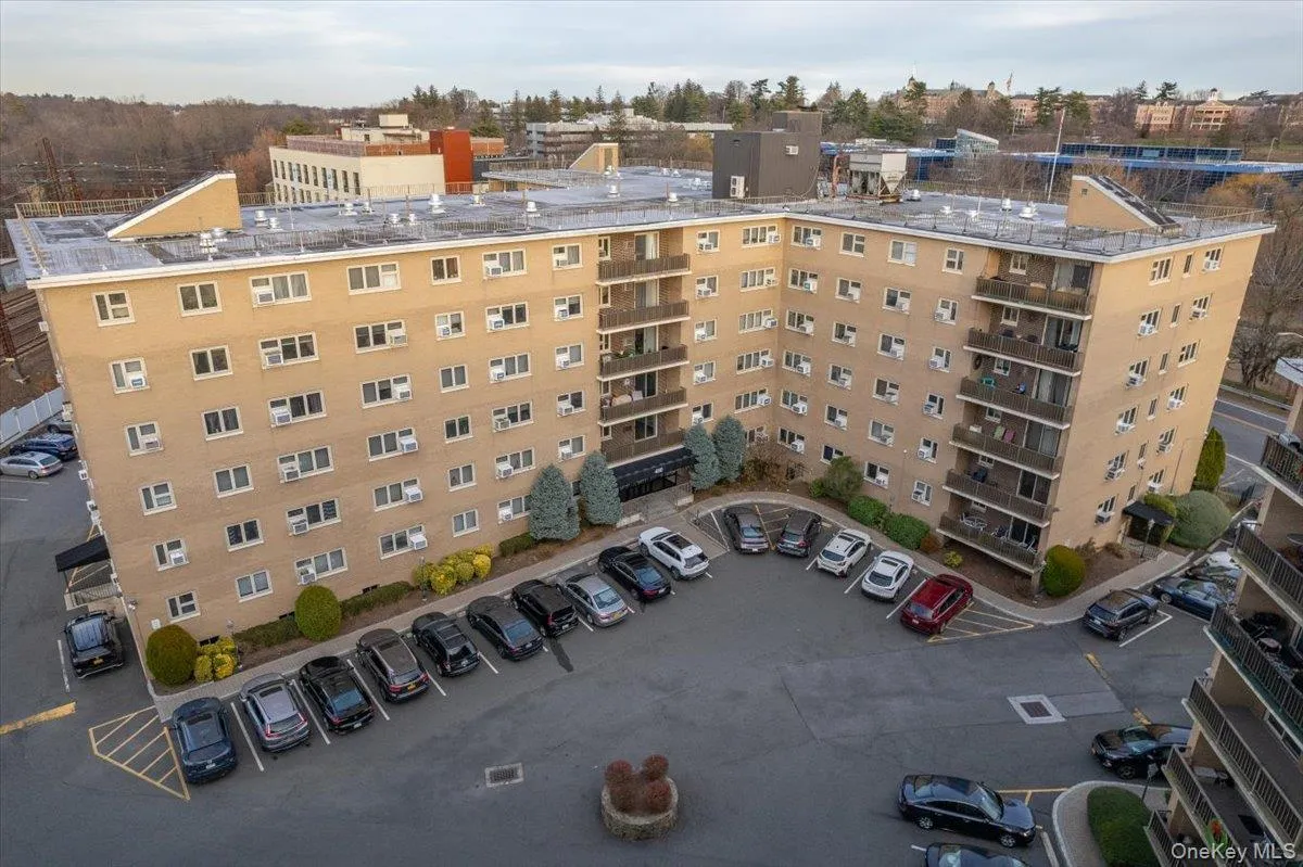 Mid-rise multi-family building featuring a brick exterior and a flat roof Mid-rise multi-family building featuring a brick exterior and a flat roof