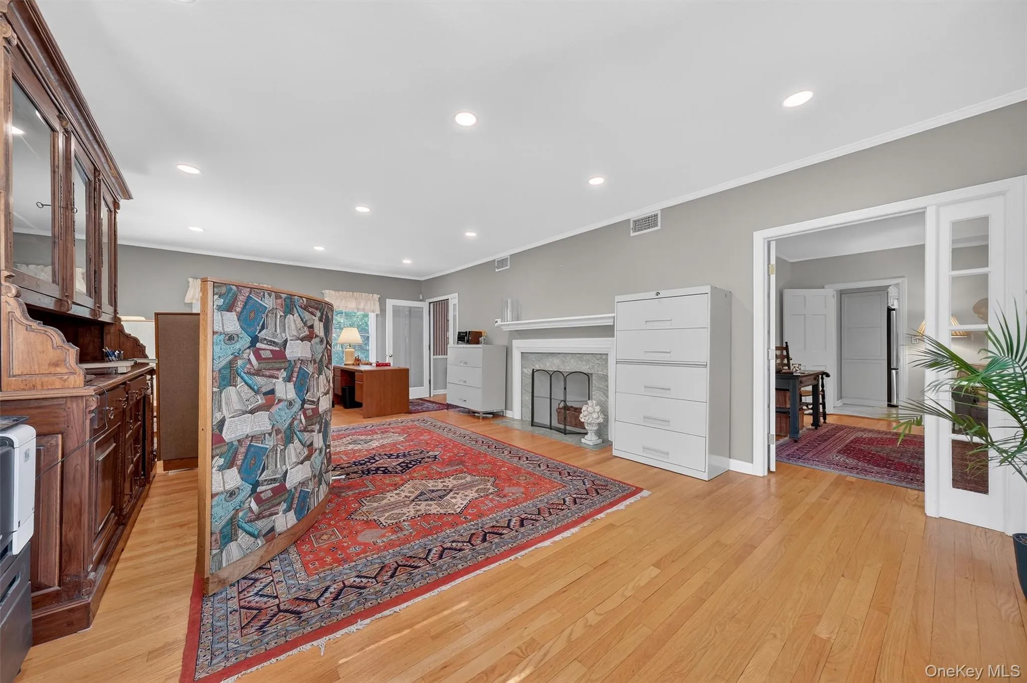 Living room with hardwood flooring, large windows and fireplace Living room with hardwood flooring, large windows and fireplace