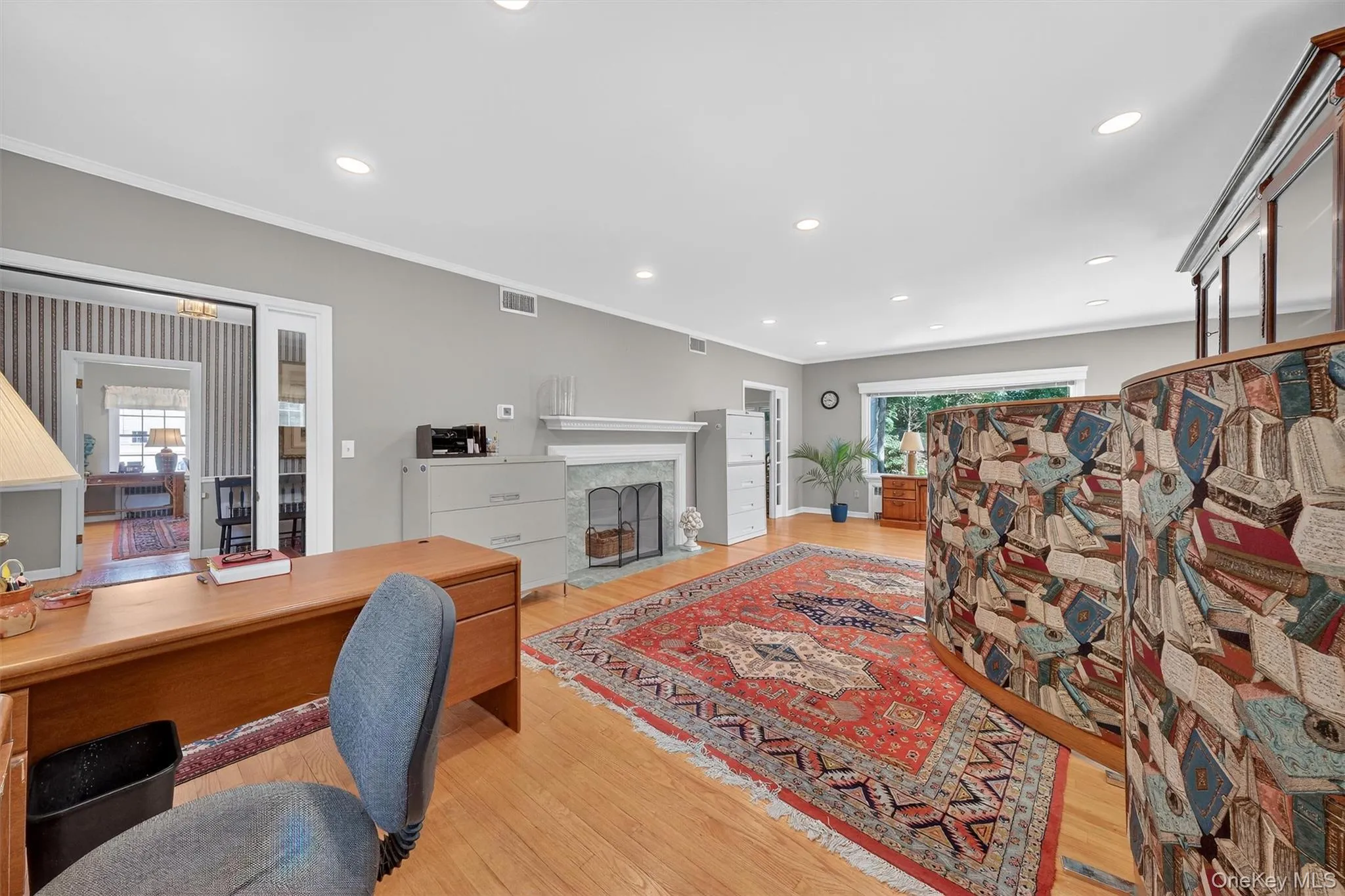 Living room with hardwood flooring, large windows and fireplace Living room with hardwood flooring, large windows and fireplace