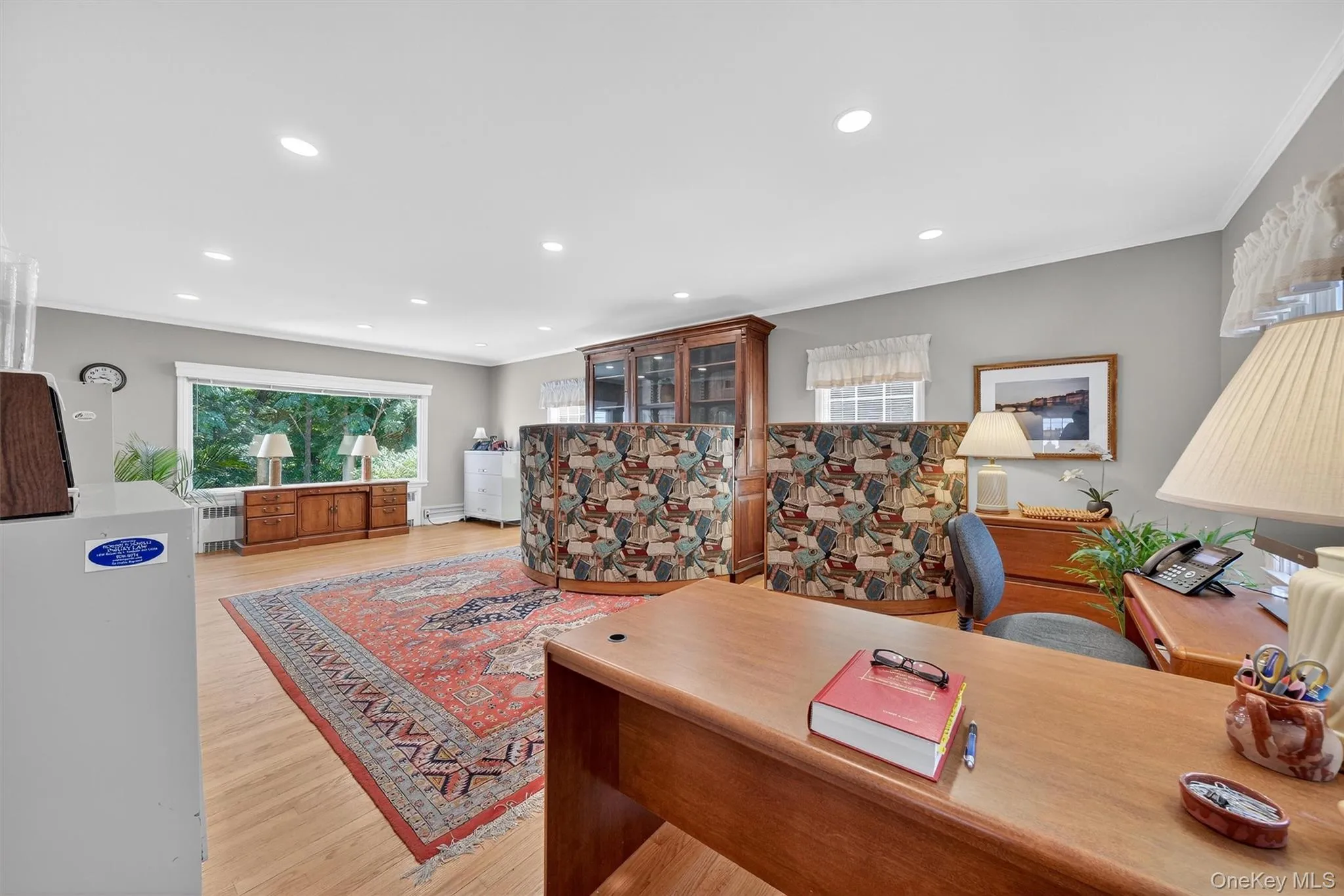 Living room with hardwood flooring, large windows and fireplace Living room with hardwood flooring, large windows and fireplace