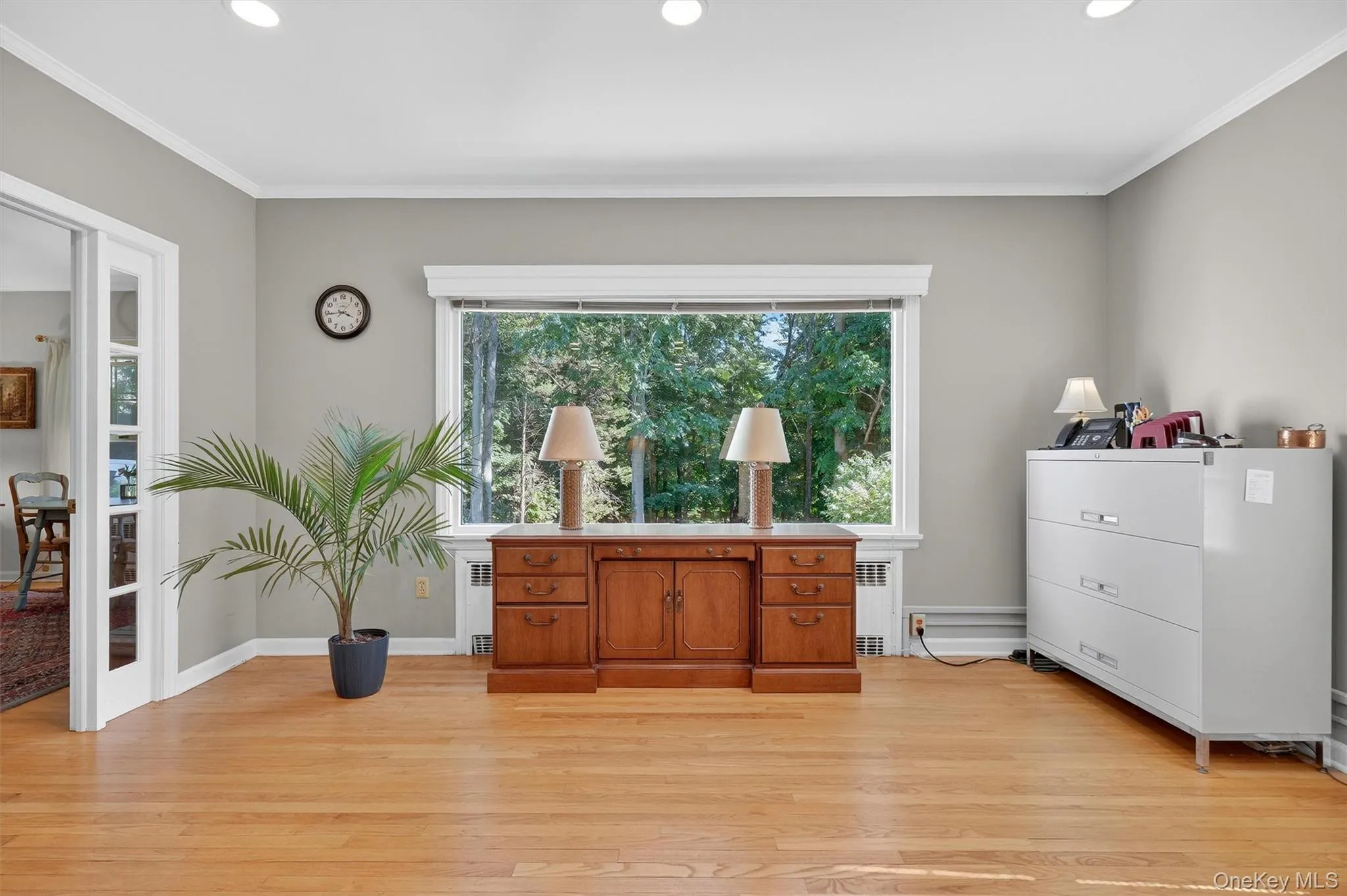Living room with hardwood flooring, large windows and fireplace Living room with hardwood flooring, large windows and fireplace