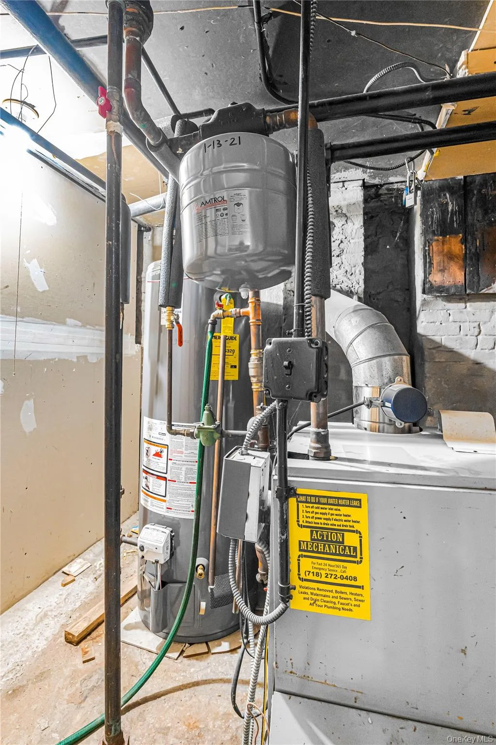 Mechanical room featuring a water heater, expansion tank, and furnace Mechanical room featuring a water heater, expansion tank, and furnace