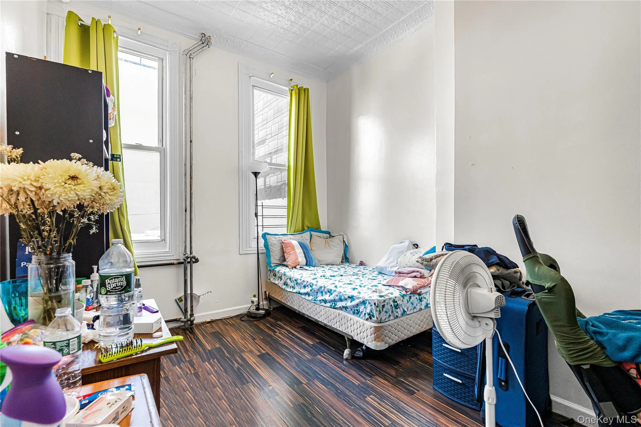 Room featuring wood-finish flooring and white painted walls Room featuring wood-finish flooring and white painted walls
