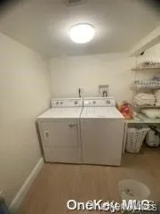 Washroom with washer and dryer and baseboards Washroom with washer and dryer and baseboards