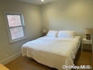 Bedroom featuring baseboards and wood finished floors Bedroom featuring baseboards and wood finished floors