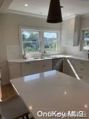 Kitchen with light countertops, recessed lighting, and dishwasher Kitchen with light countertops, recessed lighting, and dishwasher