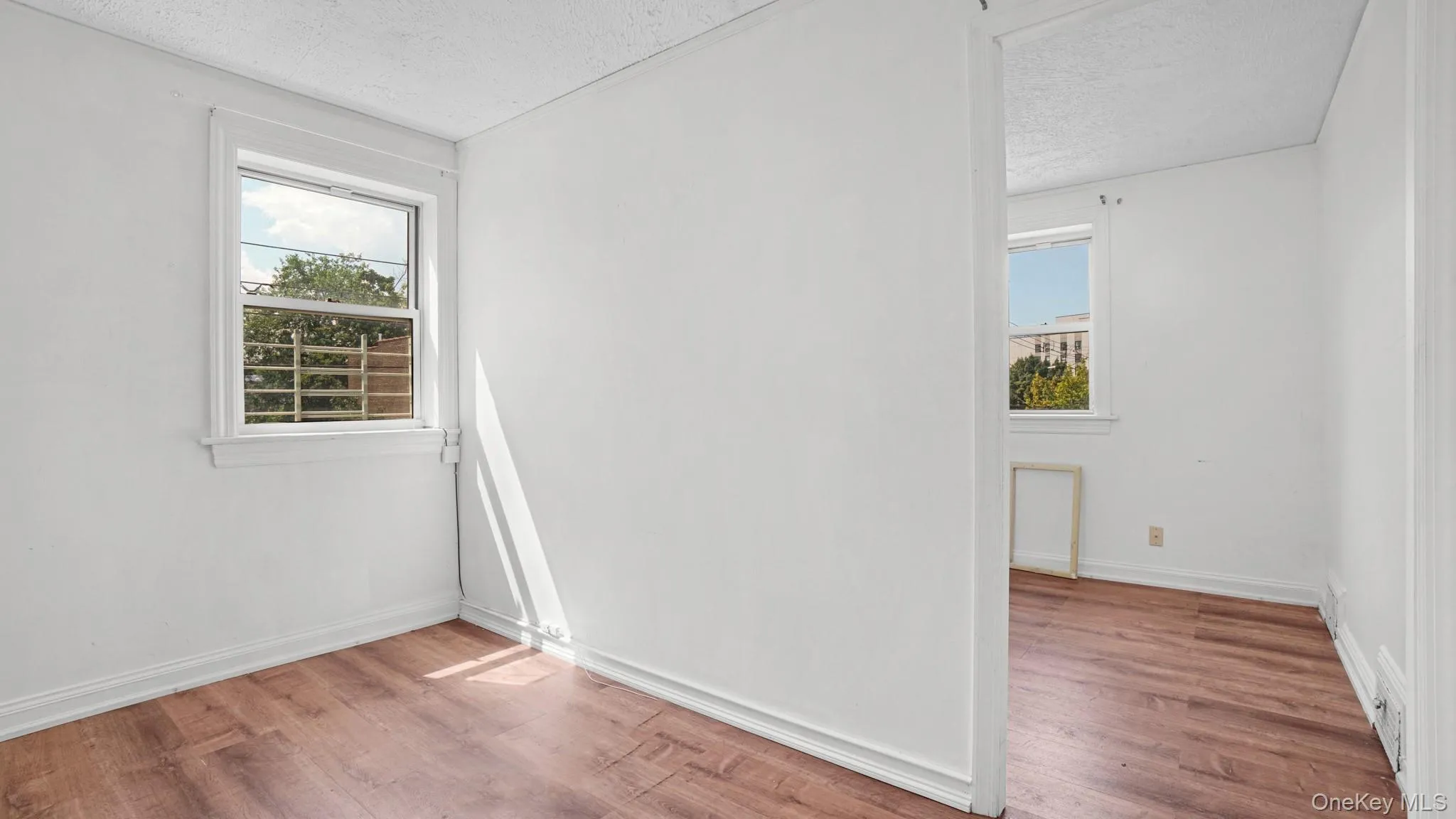 Neutral white walls with wood-finish flooring Neutral white walls with wood-finish flooring