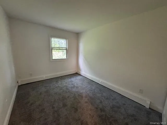 Spare #2 bedroom with carpet flooring and baseboards Spare #2 bedroom with carpet flooring and baseboards