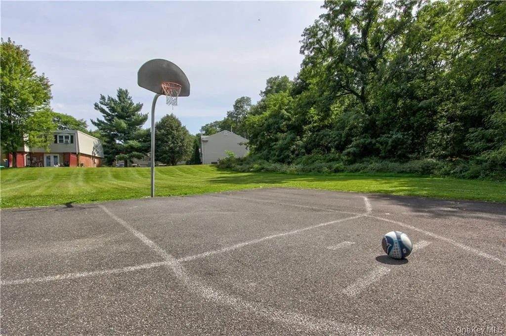 View of basketball court with a lawn View of basketball court with a lawn