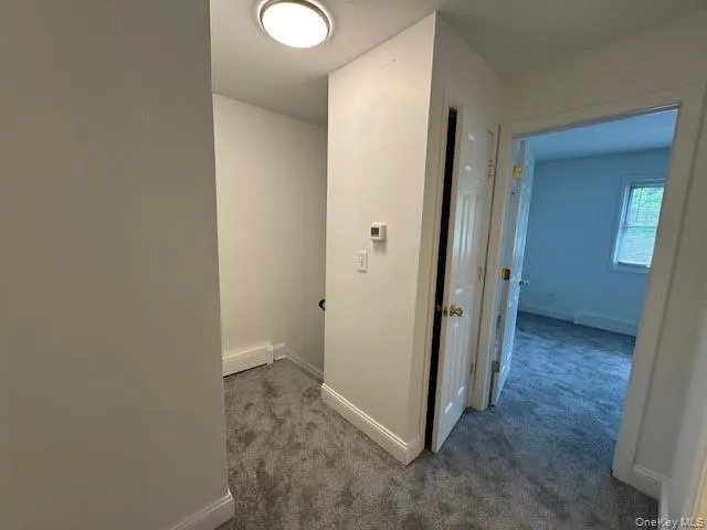Hallway/landing on second floor featuring carpet flooring Hallway/landing on second floor featuring carpet flooring