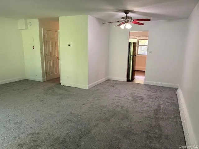 View from the living/dining area into the kitchen on the right and to the half bathroom on the left side with hallway. View from the living/dining area into the kitchen on the right and to the half bathroom on the left side with hallway.