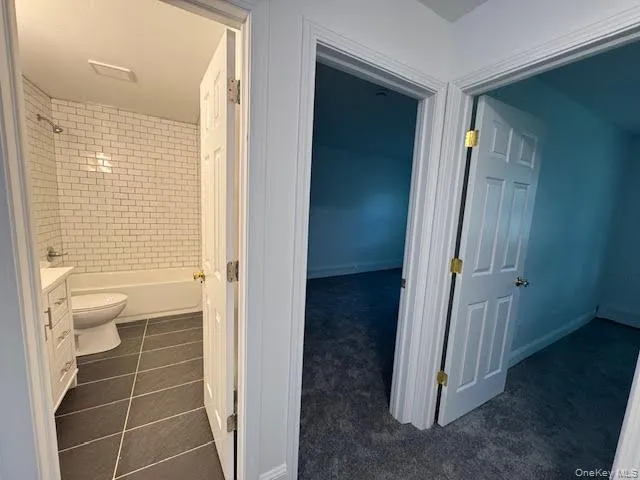 Hall featuring the entry bedrooms and full bathroom. Hall featuring the entry bedrooms and full bathroom.