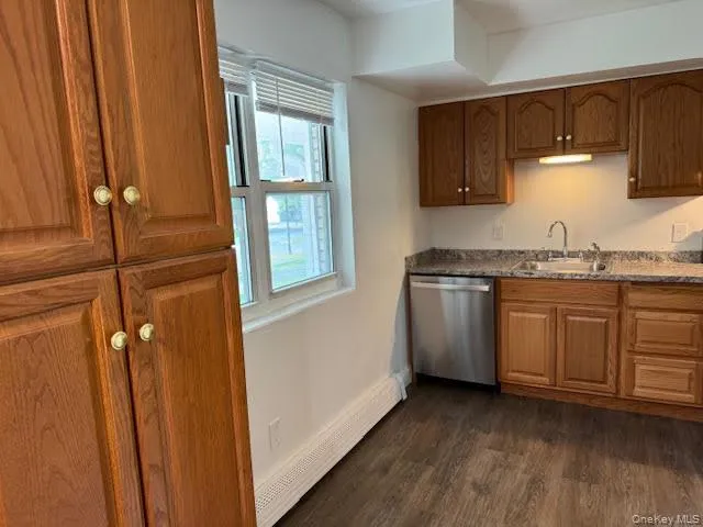 Kitchen with pantry, large window, wood cabinets and stainless steel appliances. Kitchen with pantry, large window, wood cabinets and stainless steel appliances.
