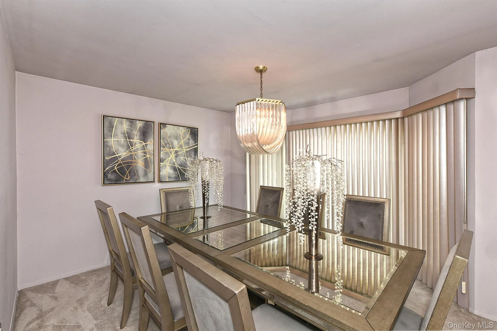 Dining area with wall-to-wall carpeting and a bay window featuring vertical blinds Dining area with wall-to-wall carpeting and a bay window featuring vertical blinds