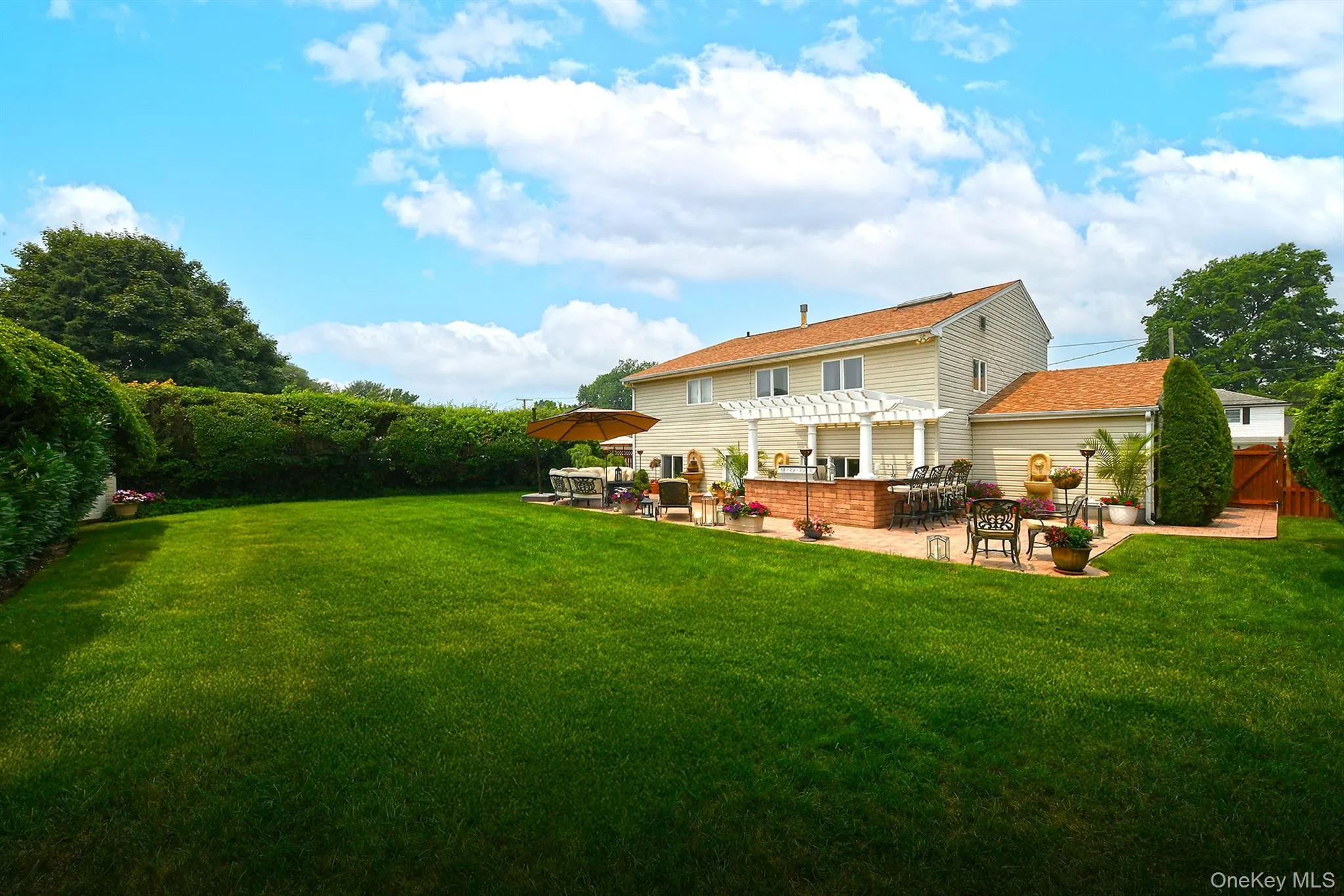 Expansive green lawn with mature perimeter hedges Expansive green lawn with mature perimeter hedges