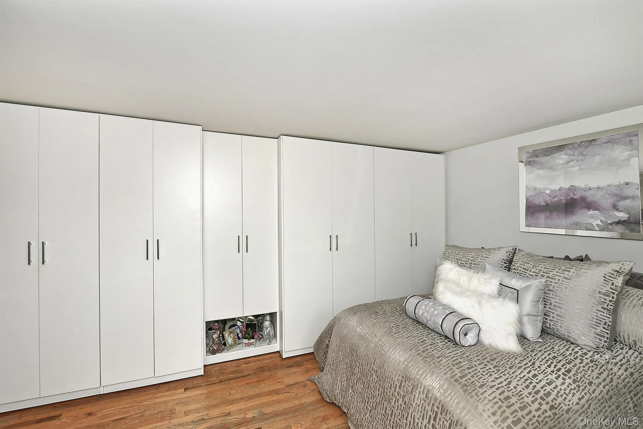 Integrated white cabinetry providing extensive storage solutions Integrated white cabinetry providing extensive storage solutions