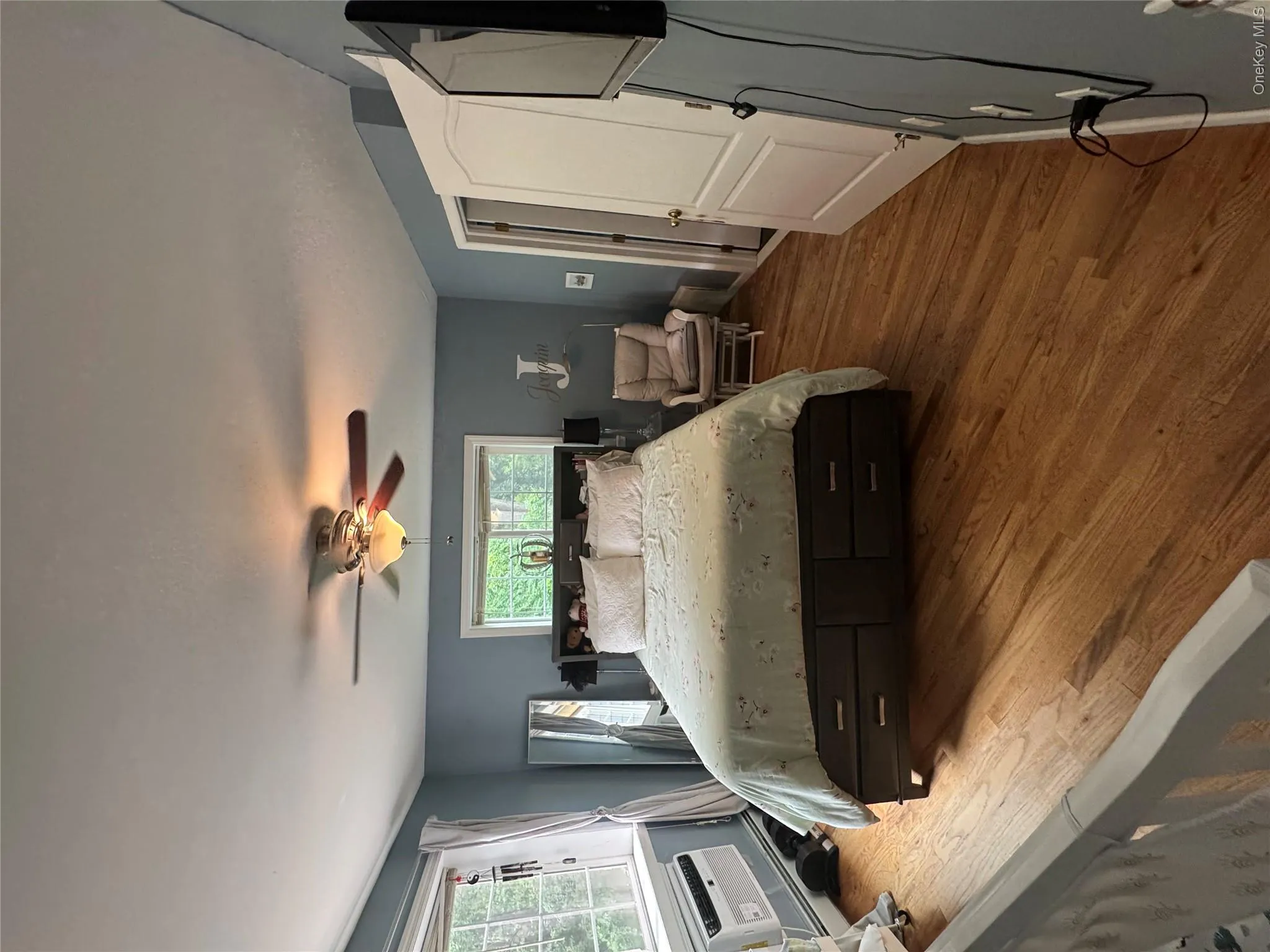 Hardwood flooring extends throughout this room, featuring a ceiling fan with integrated lighting Hardwood flooring extends throughout this room, featuring a ceiling fan with integrated lighting