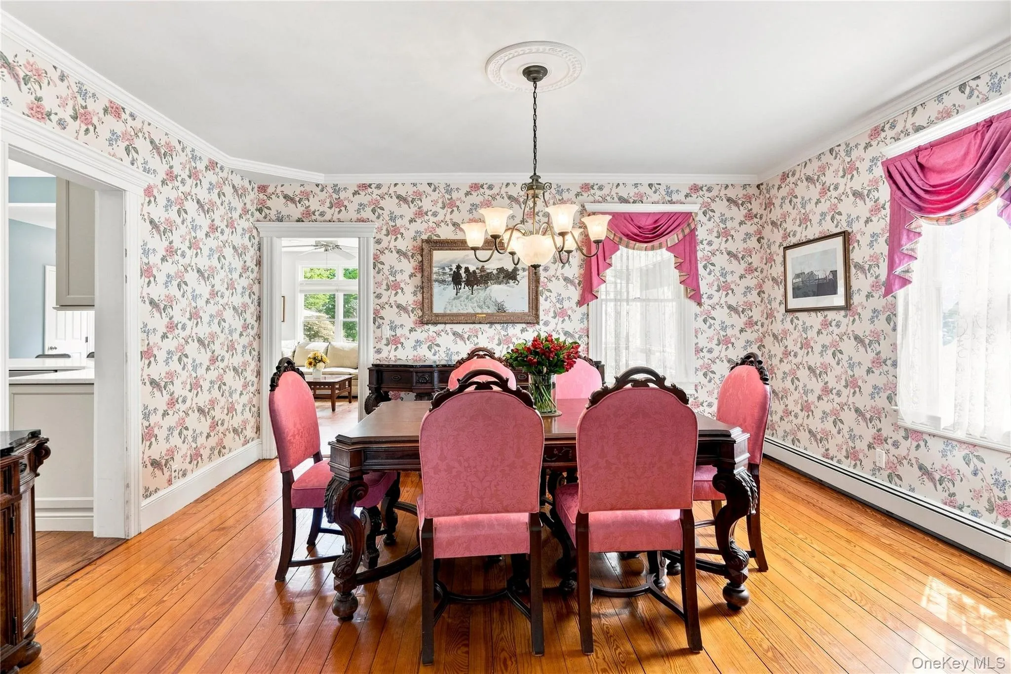 Wood-finish flooring, floral wallpaper, and crown molding Wood-finish flooring, floral wallpaper, and crown molding